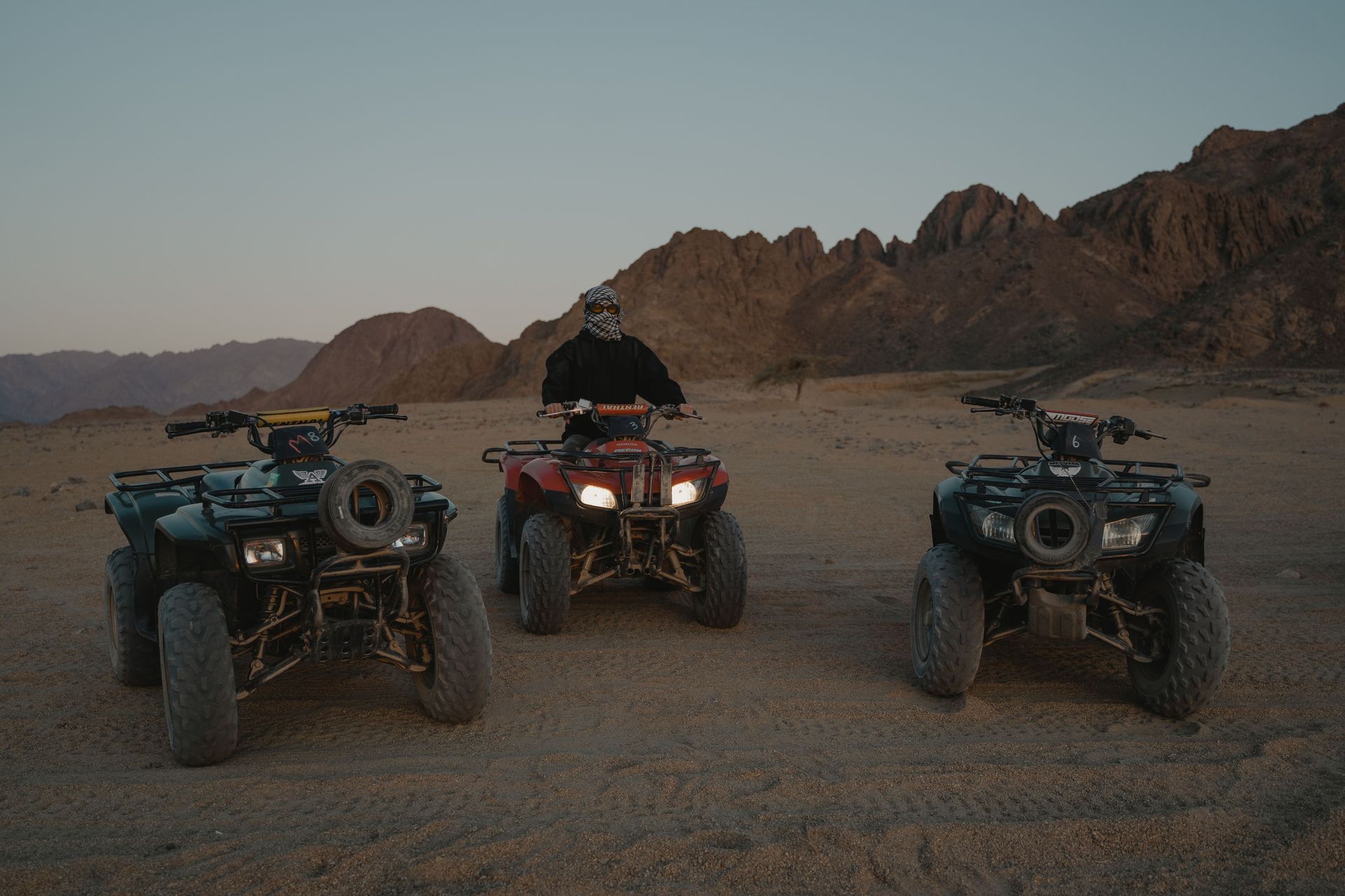 A side-by-side UTV parked on a dirt trail on a rural Texas ranch property with open pasture in the background