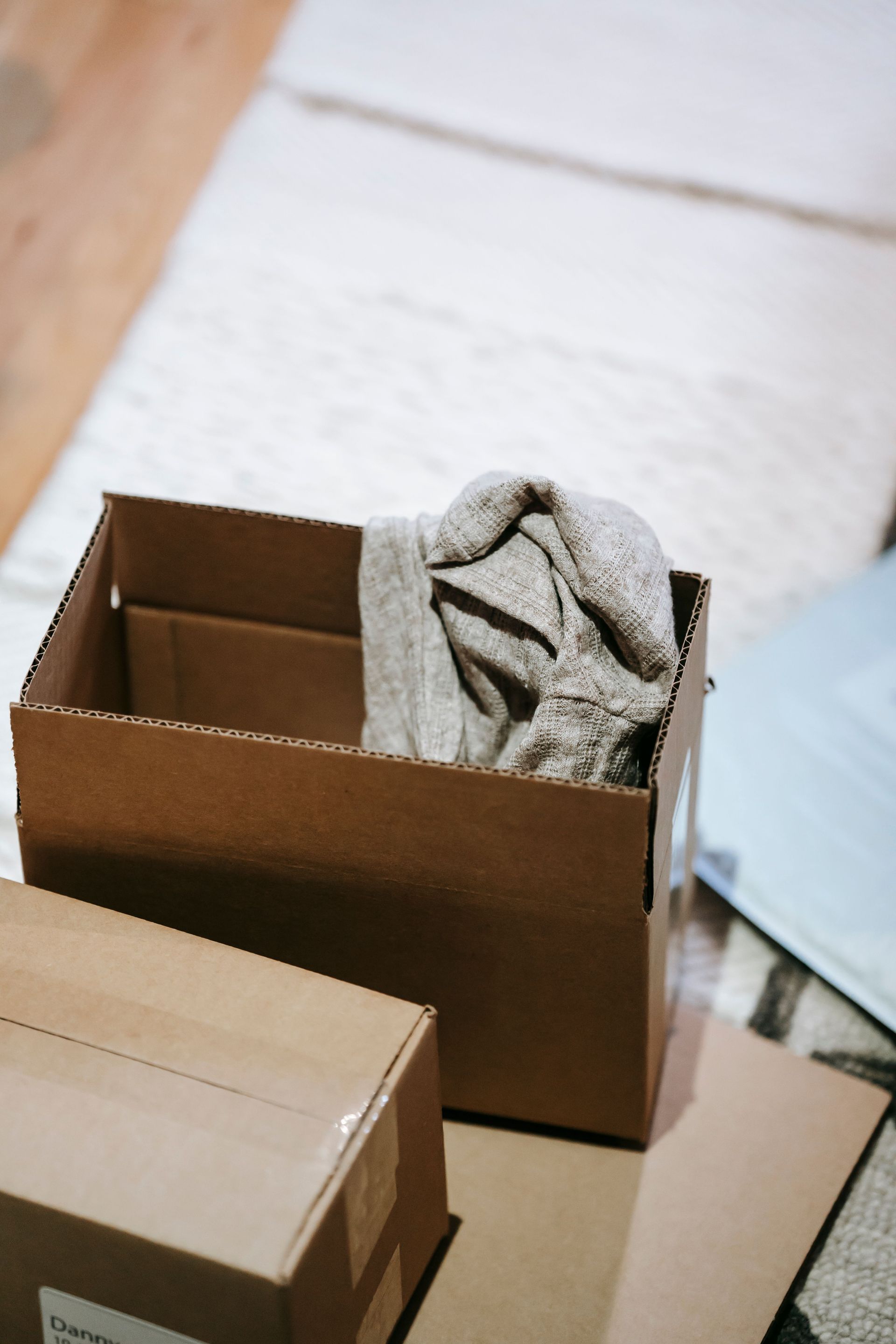 Stack of moving boxes in an empty hallway, the in-between moment when a Texas home sits unoccupied