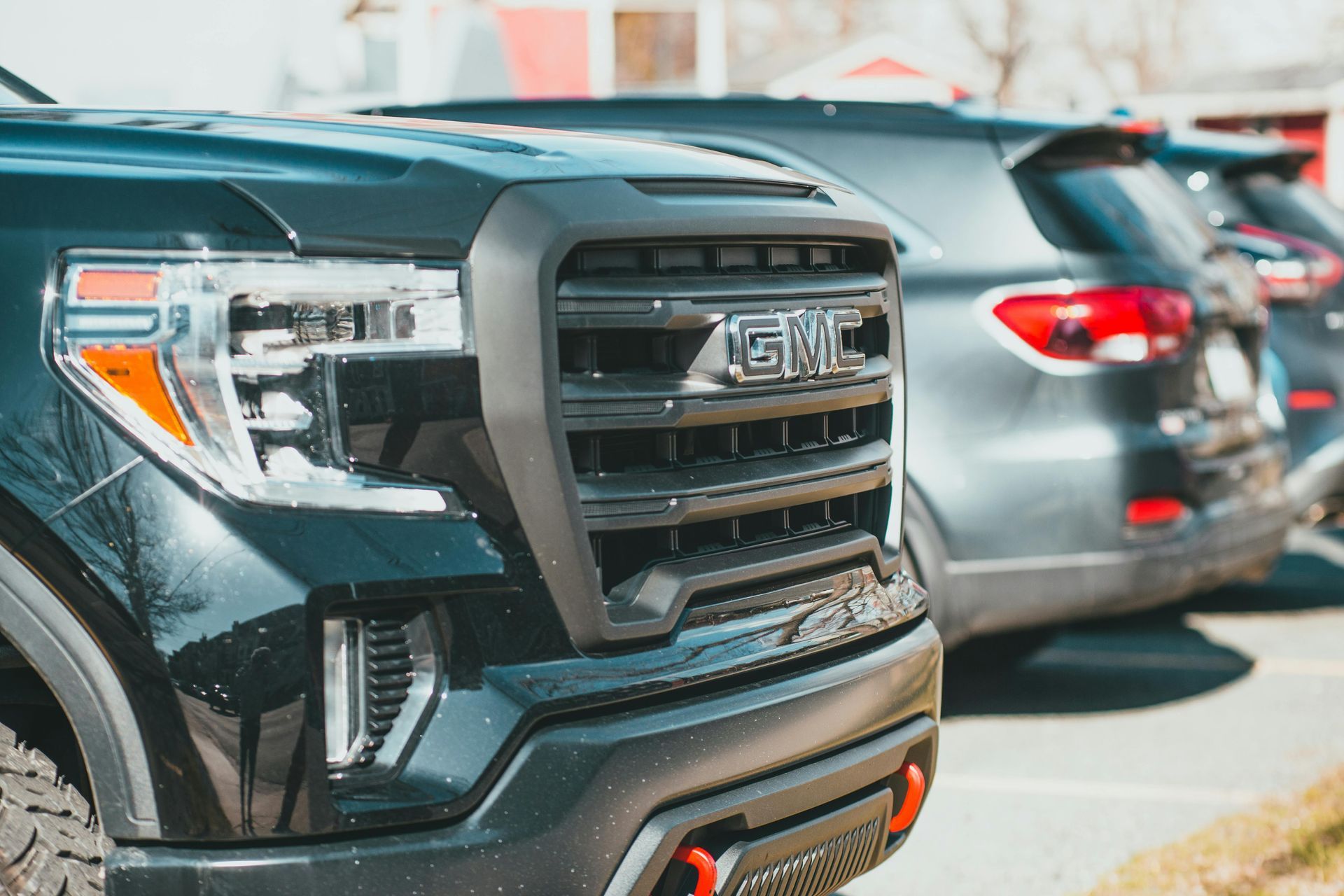 A close-up of a black GMC pickup truck parked outdoors for TAP Insurance Agency