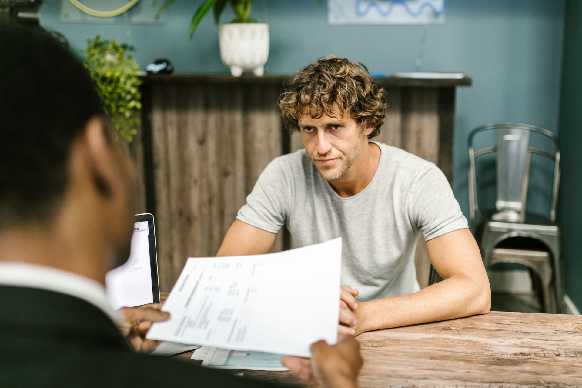A Texas small business owner reviewing commercial flood insurance coverage options with an independent agent