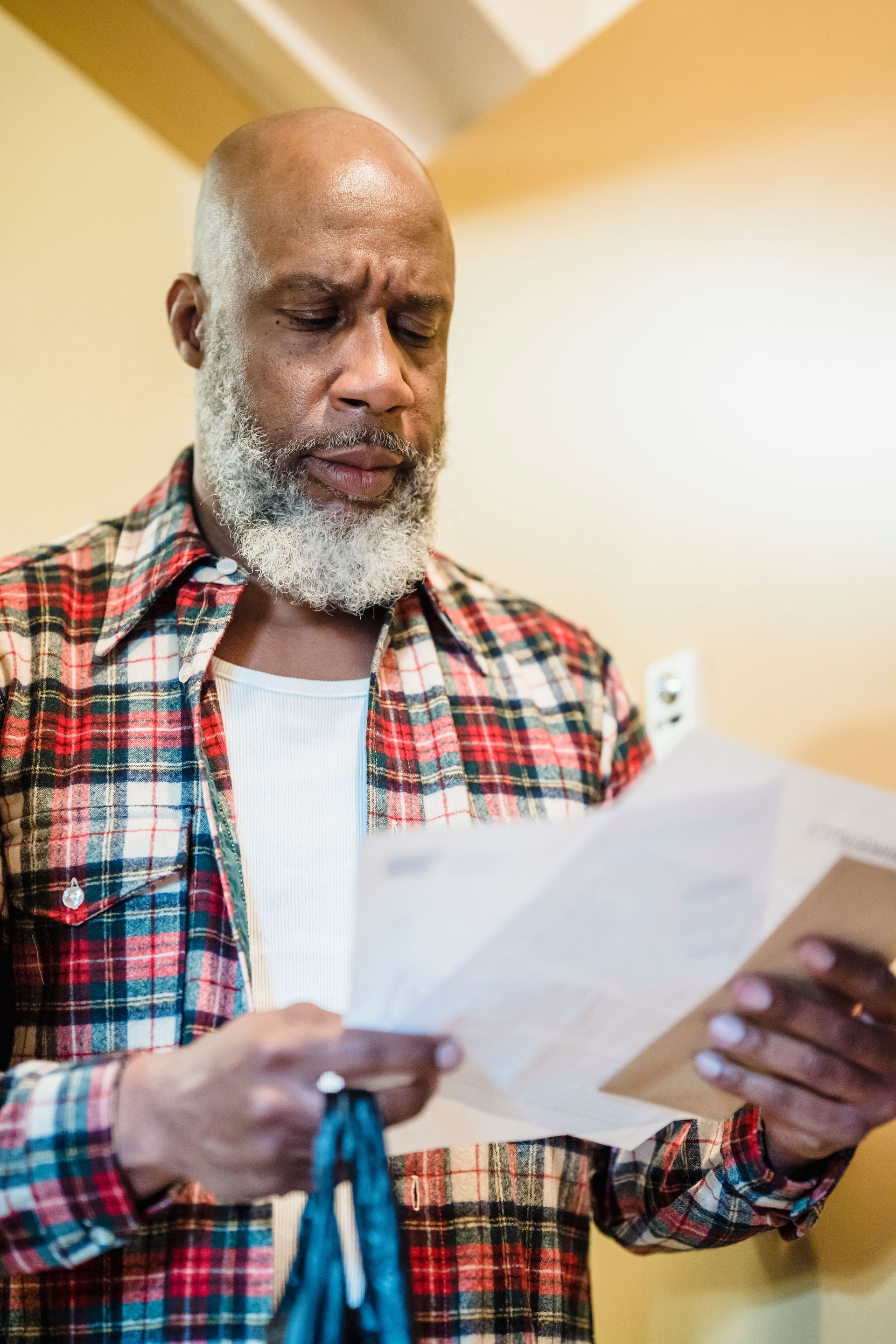 A homeowner reading the declarations page of a Texas homeowners policy, looking for the wind and hail deductible line
