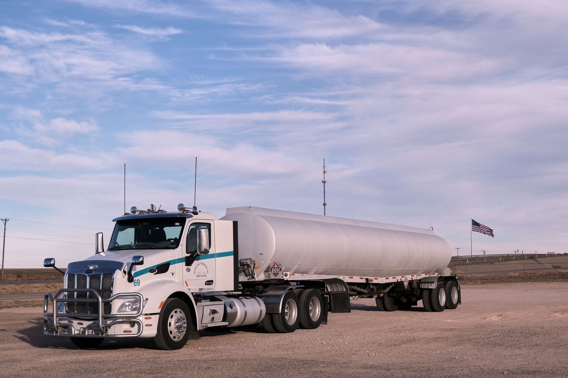 Semi-truck parked at a rural North Texas fuel stop with federal filing paperwork visible on the