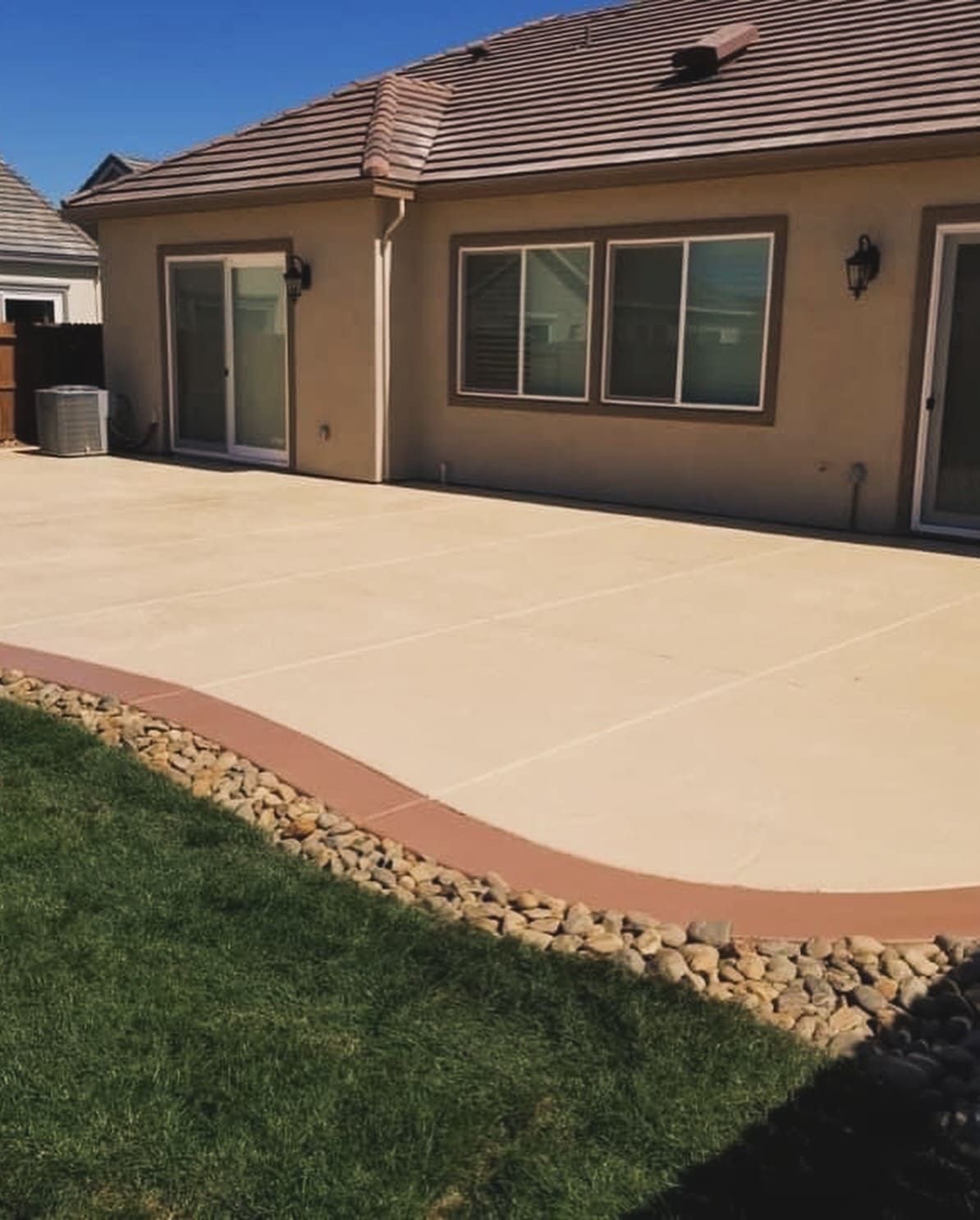 Concrete patio installed in backyard landscaping Stockton.
