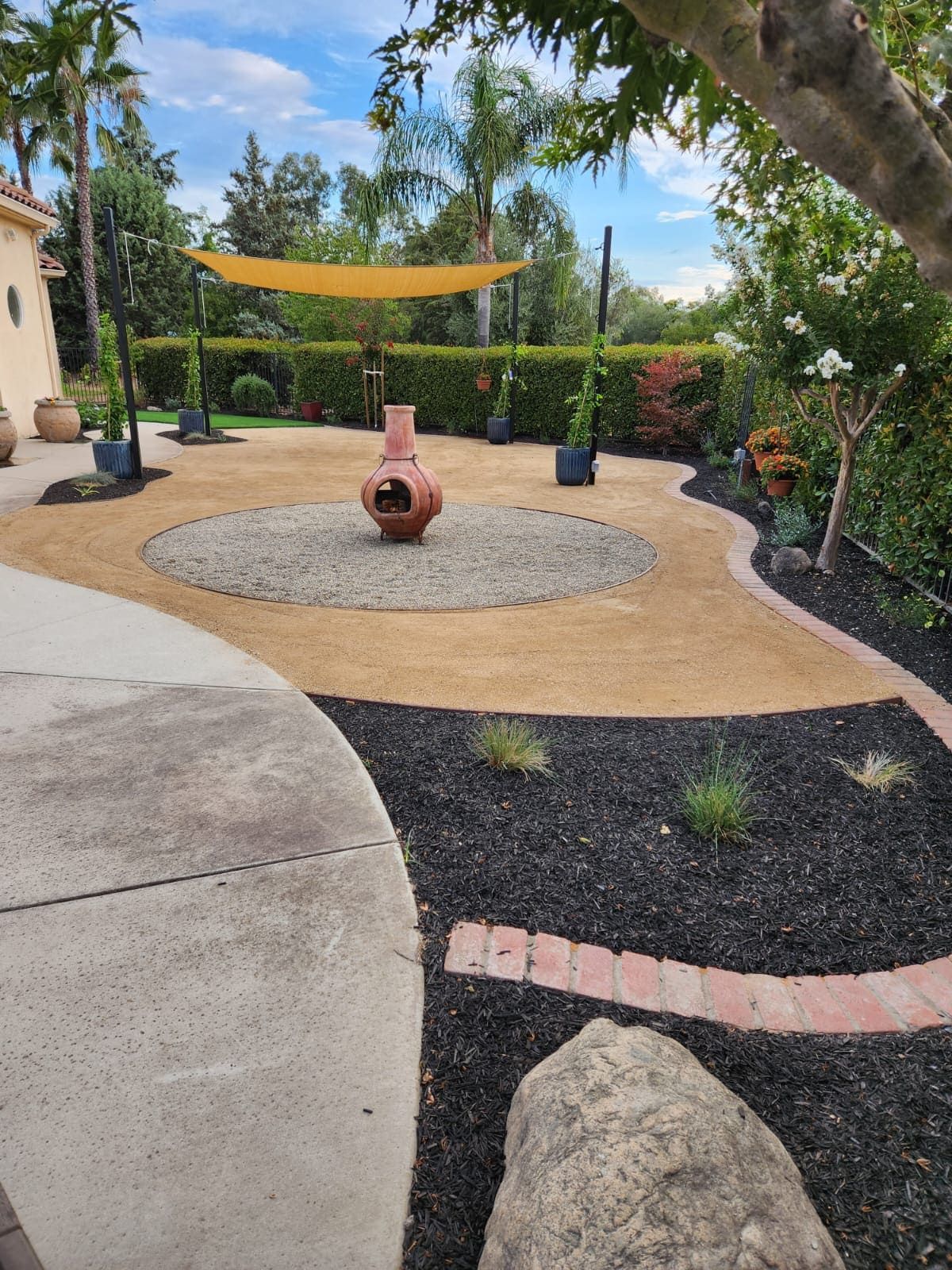 Professionally designed backyard landscape in Stockton featuring structured planting beds and hardscape elements