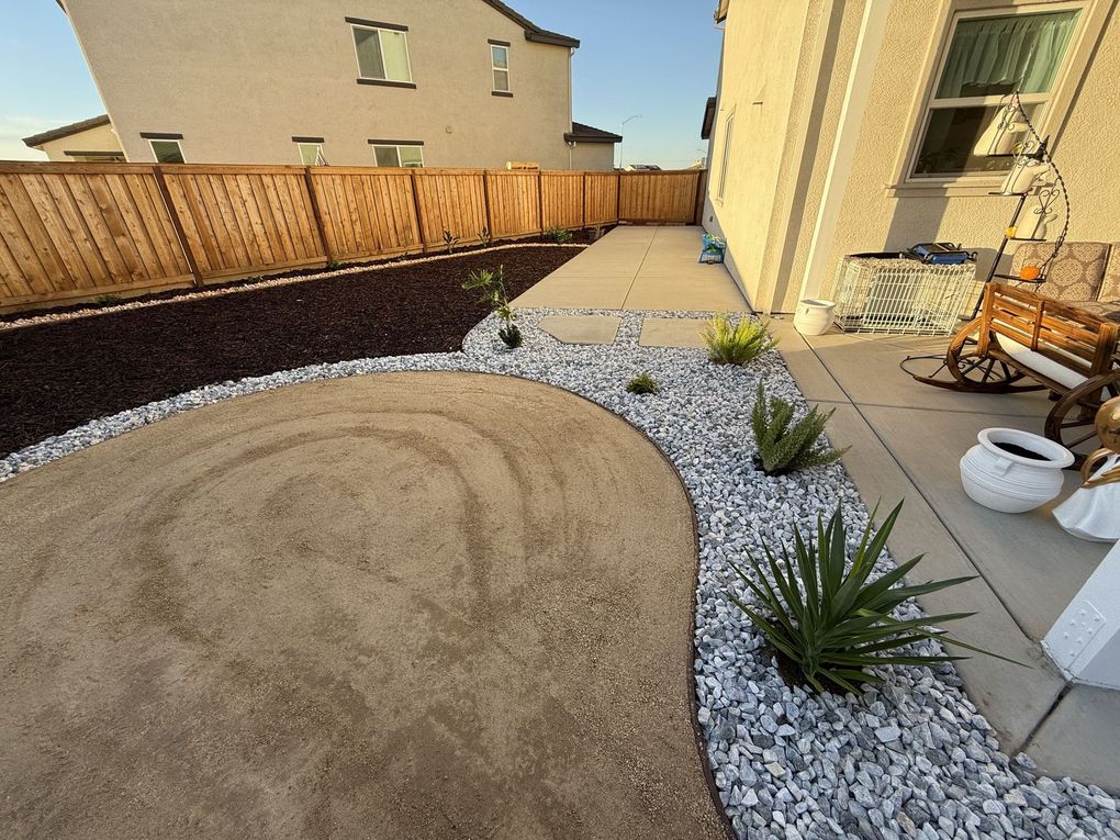 Rock, mulch and decorative ground cover installed on a patio in Stockton, CA