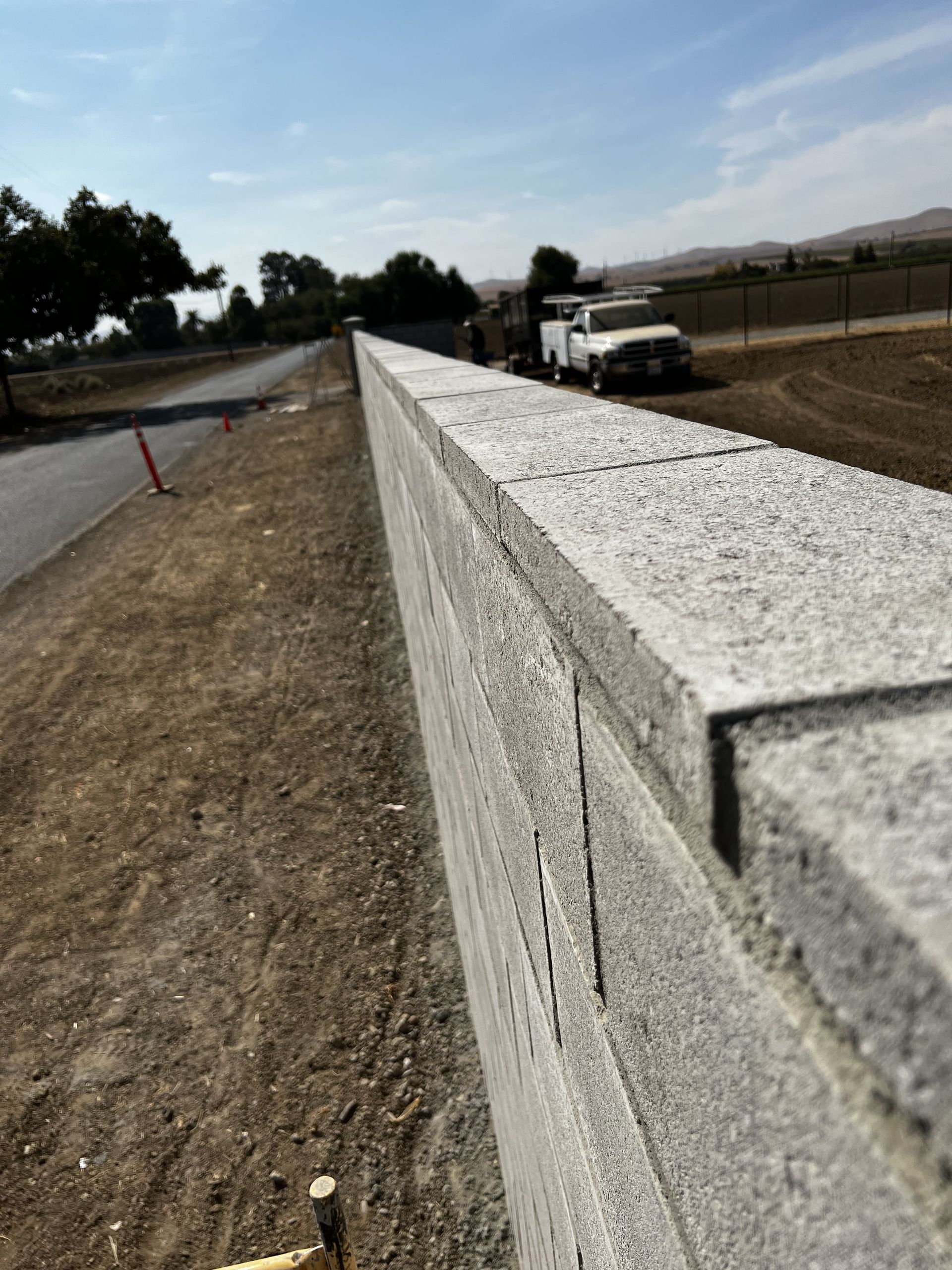 Close up view of a concrete retaining wall built by Drago Inc.