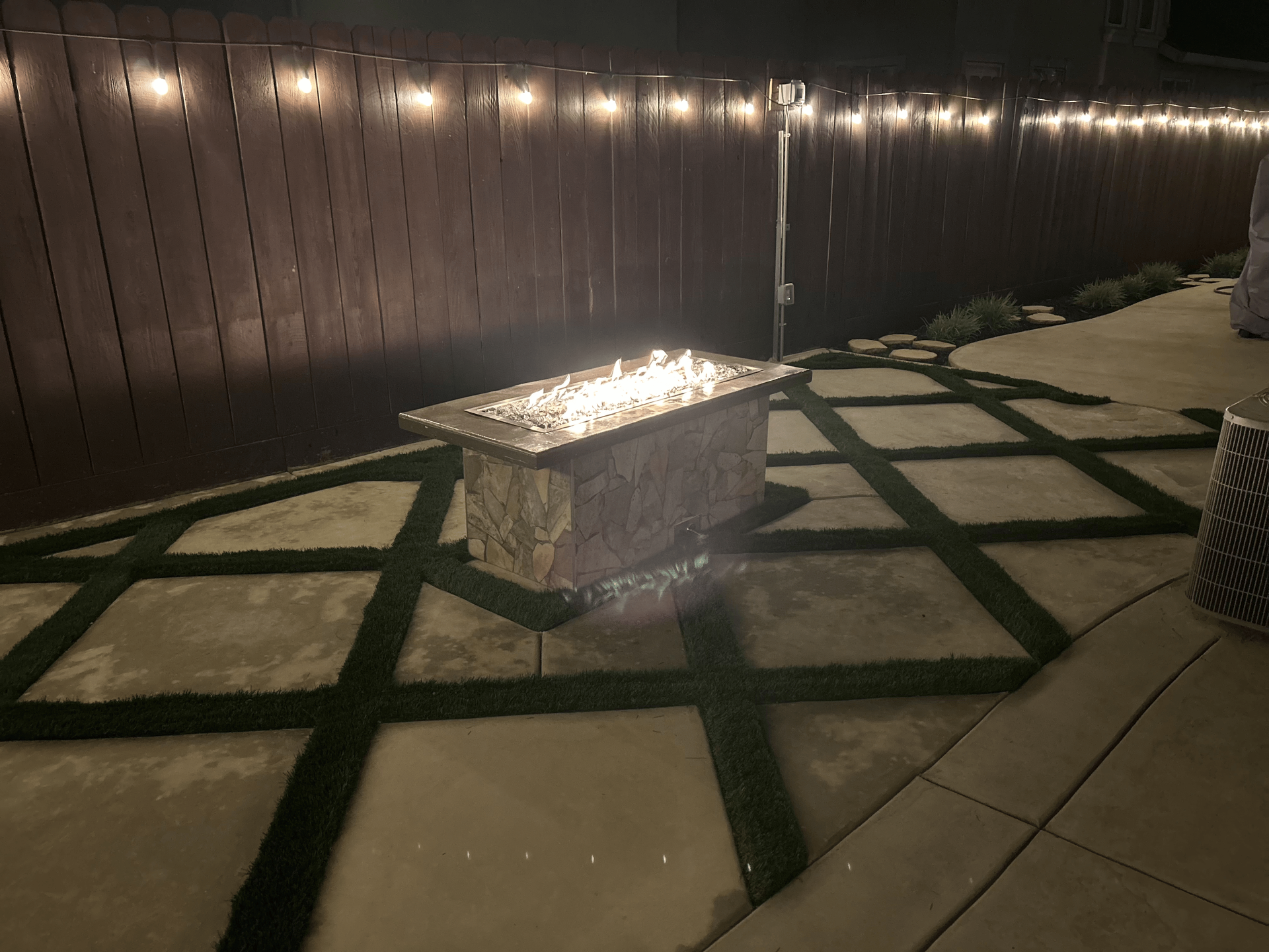 Landscape design with outdoor firepit seating area and hardscape patio in Stockton CA
