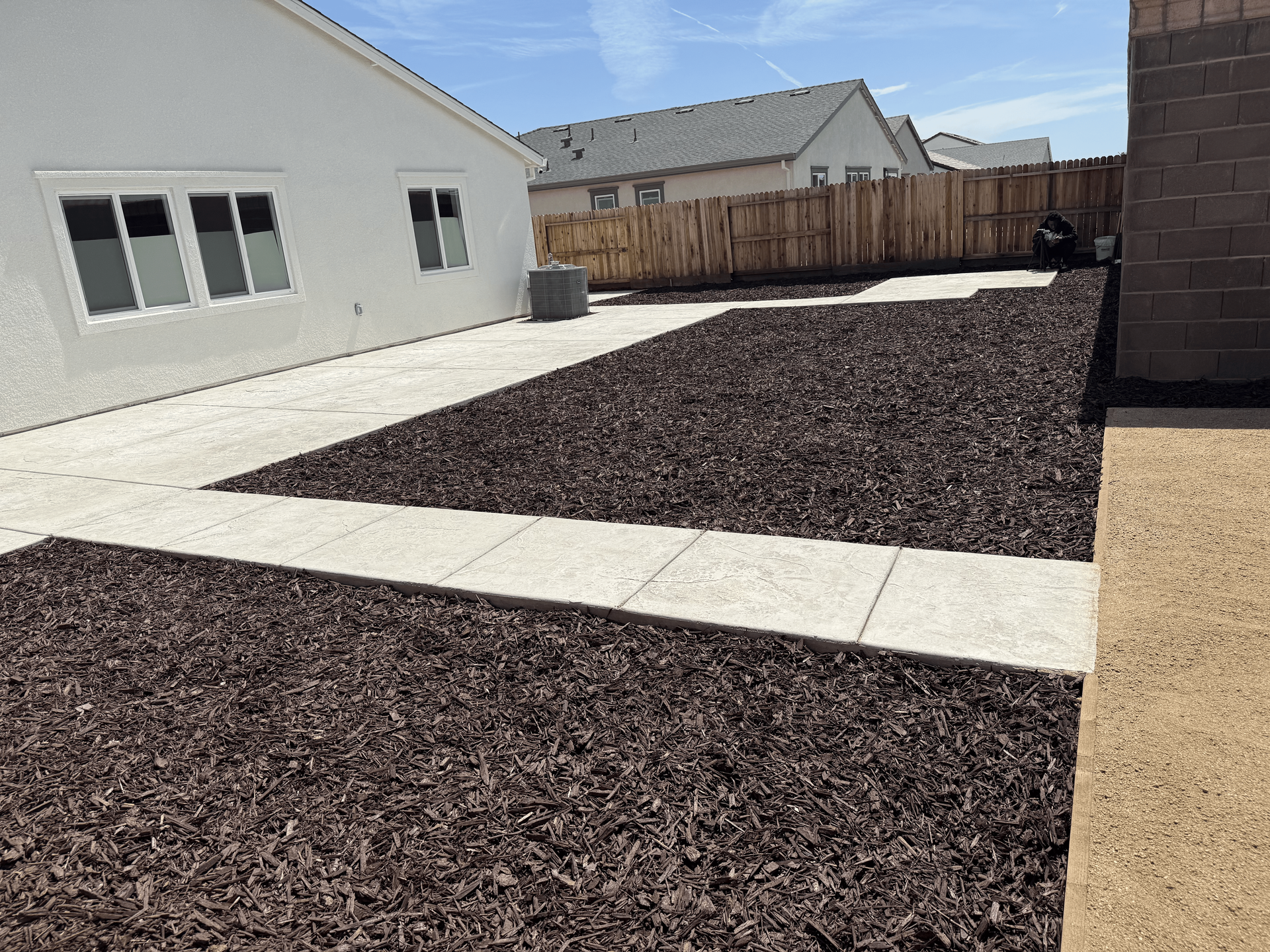 Close-up of rock, concrete, and mulch used in landscape design.