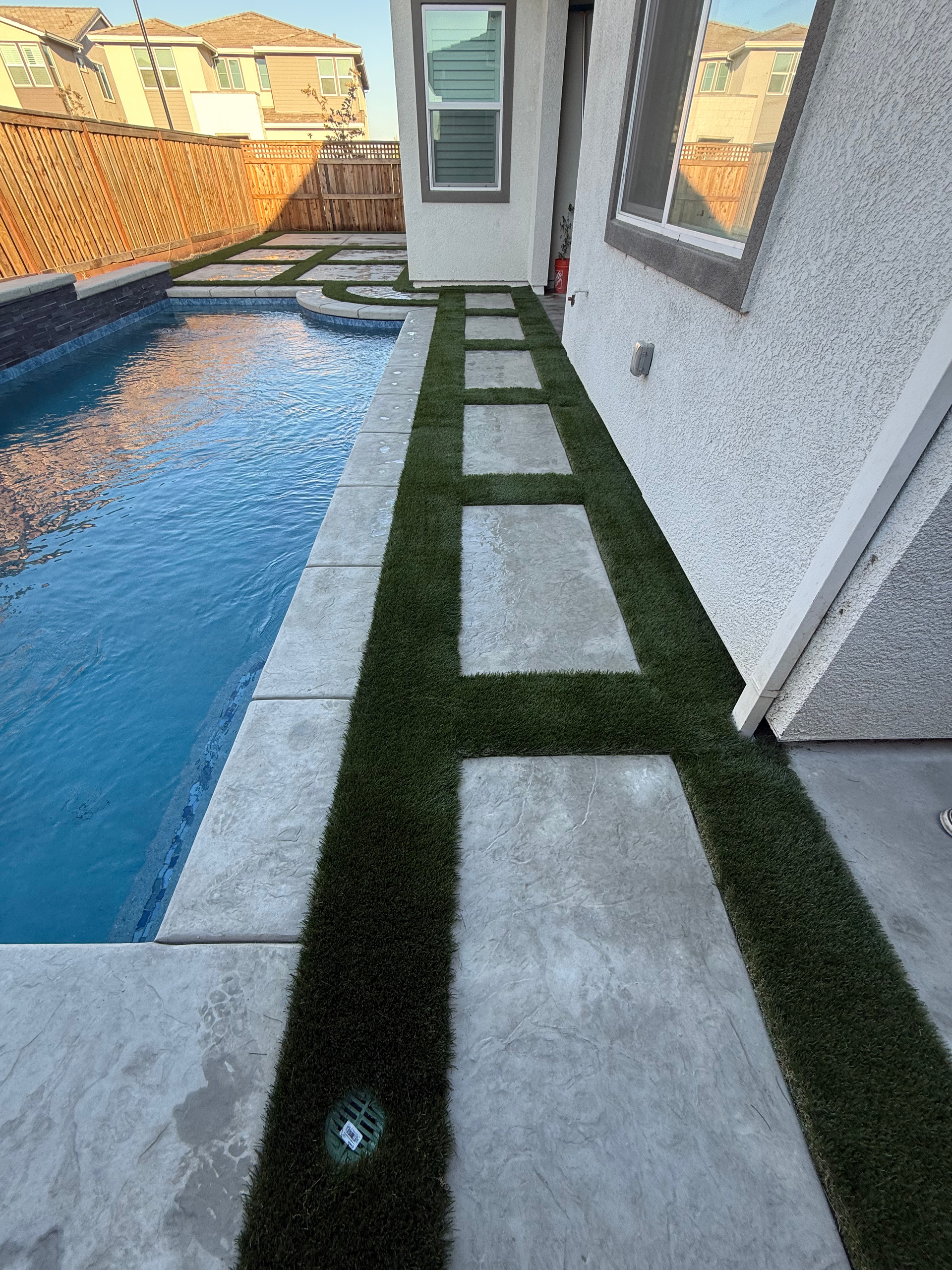 Concrete and landscape patio design by the pool in Sacramento, CA