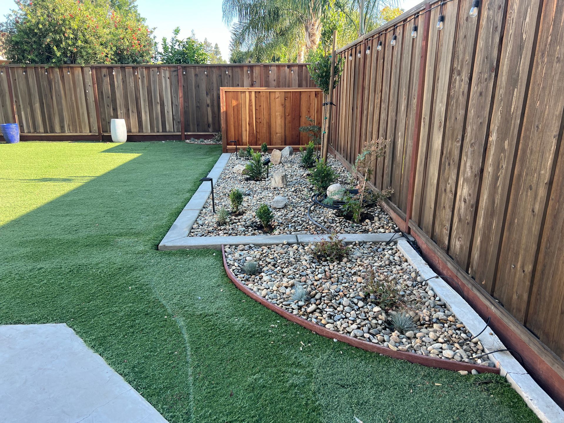 Landscape design with turf and decorative rock in Stockton CA.