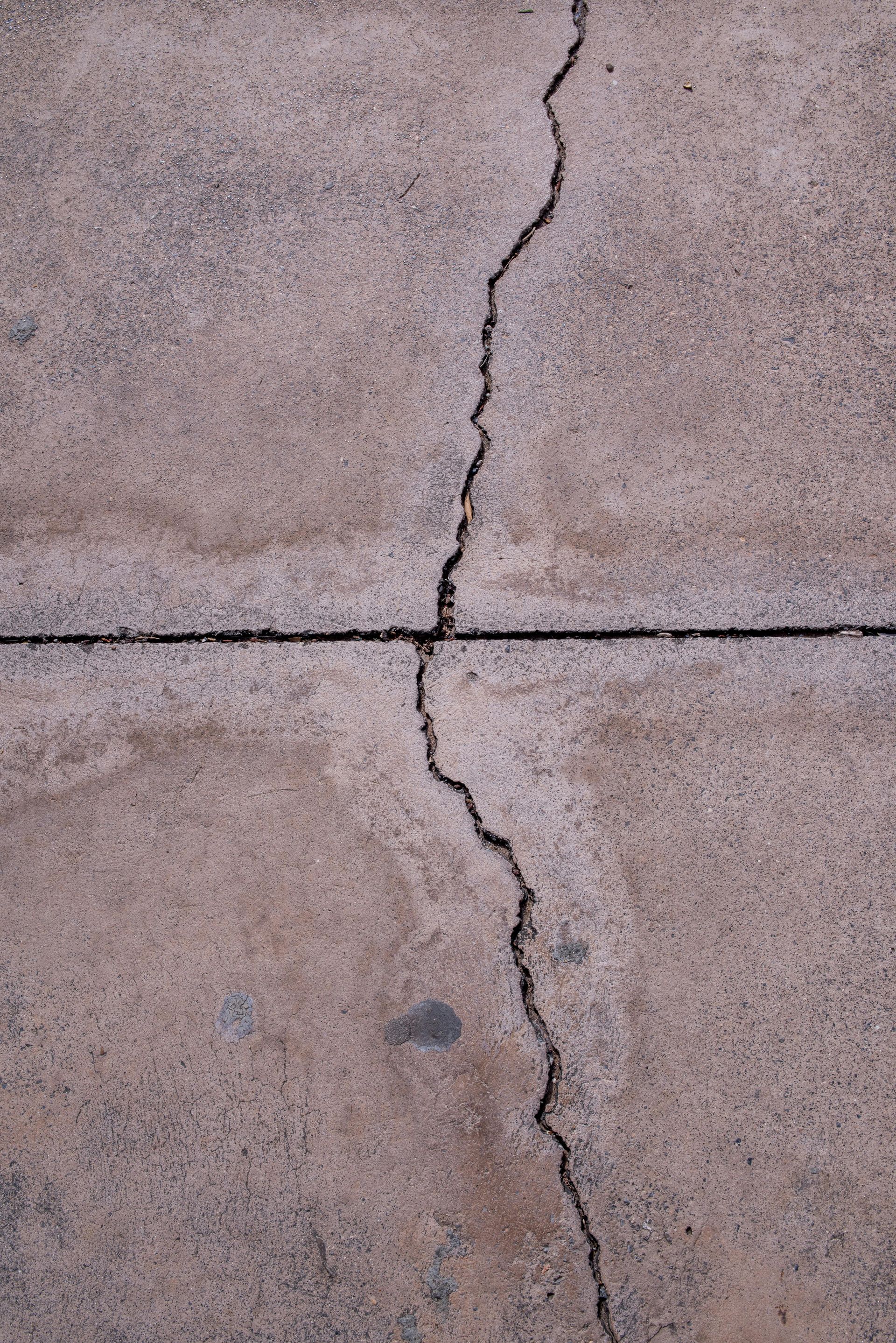 Concrete driveway with weather-related cracking and surface wear in Stockton CA