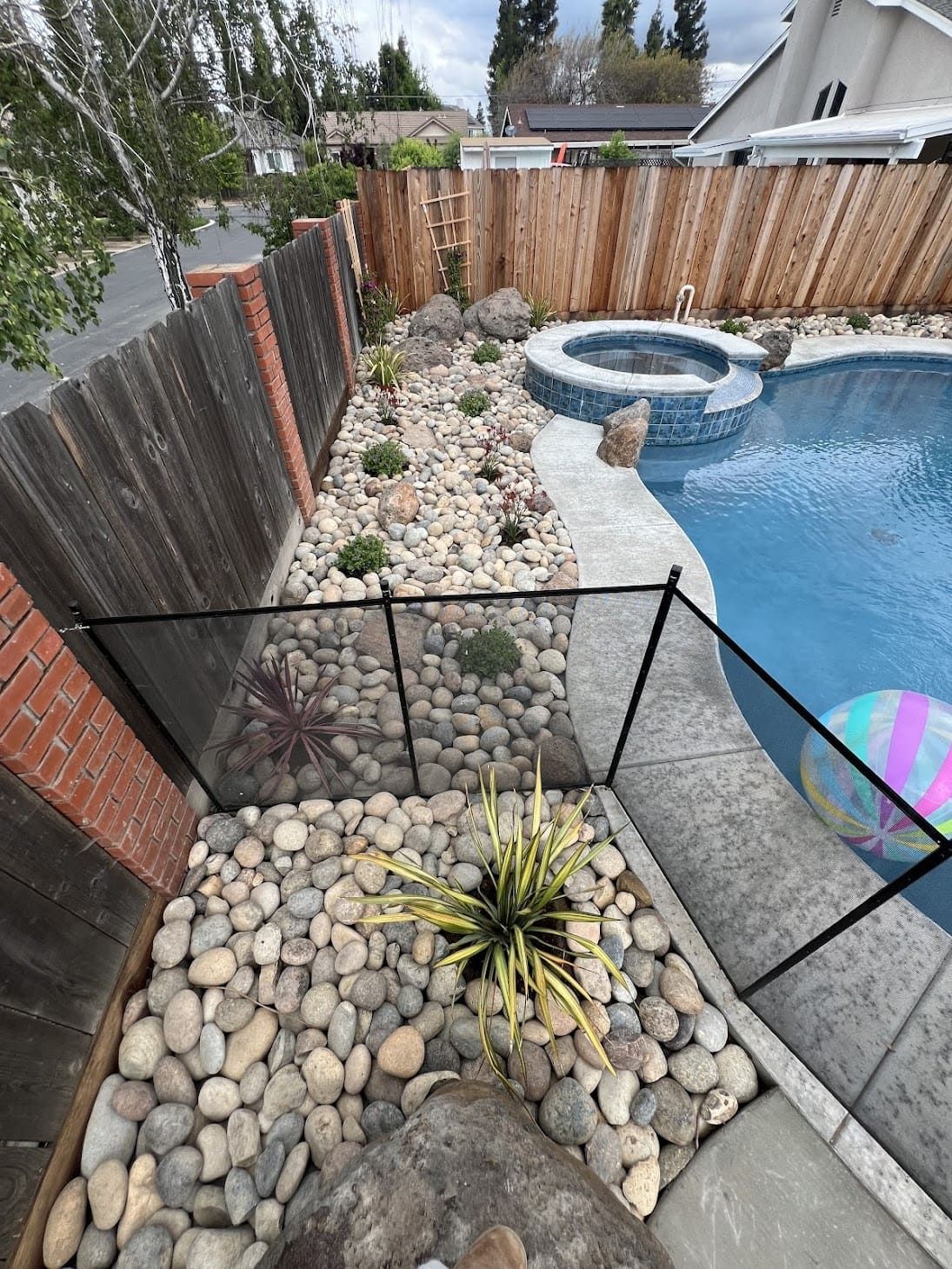 Residential poolside landscaping with custom plants, turf, and modern outdoor design in Stockton