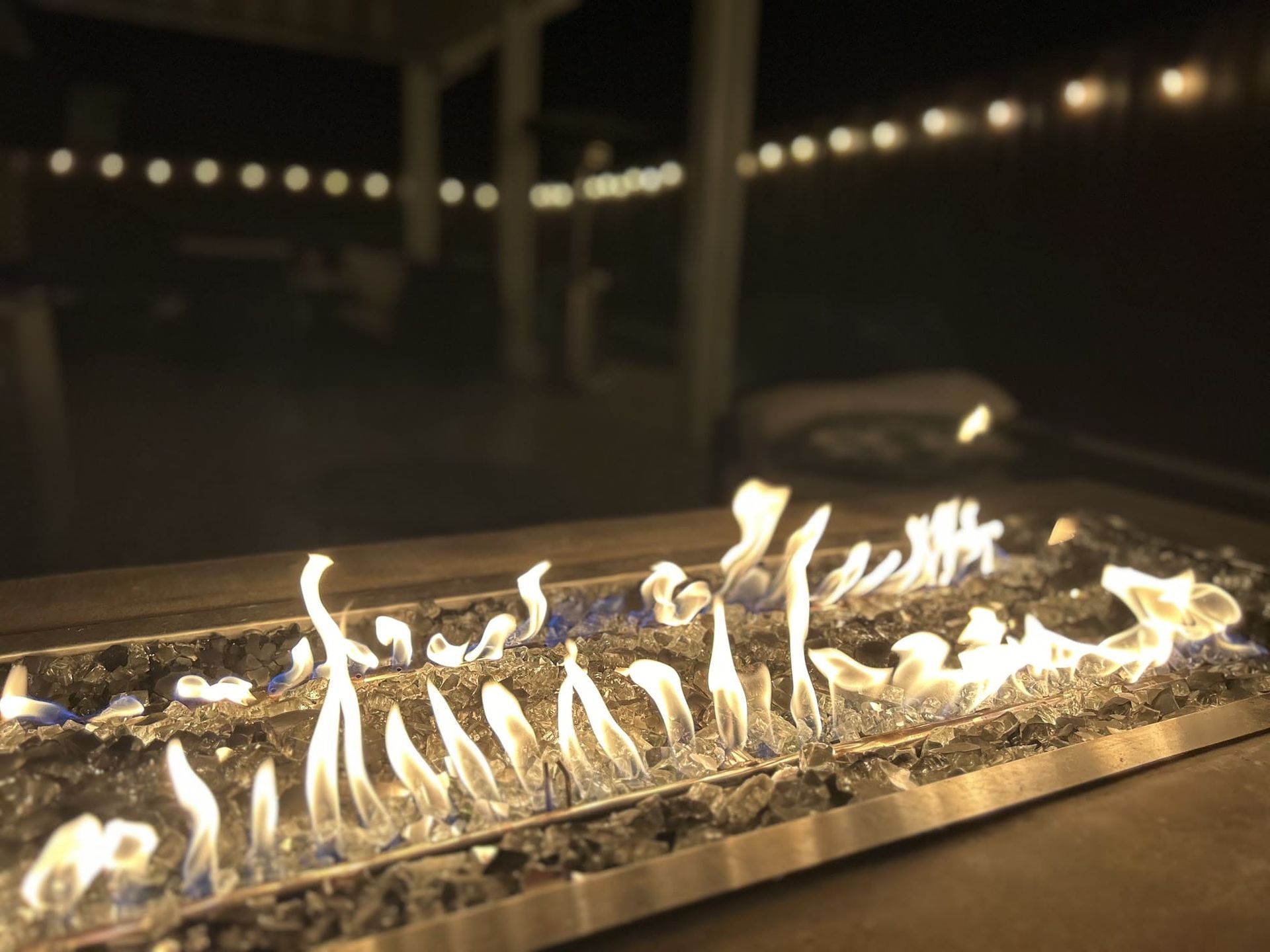 Custom stone firepit built on a Stockton patio, creating a cozy outdoor living space.