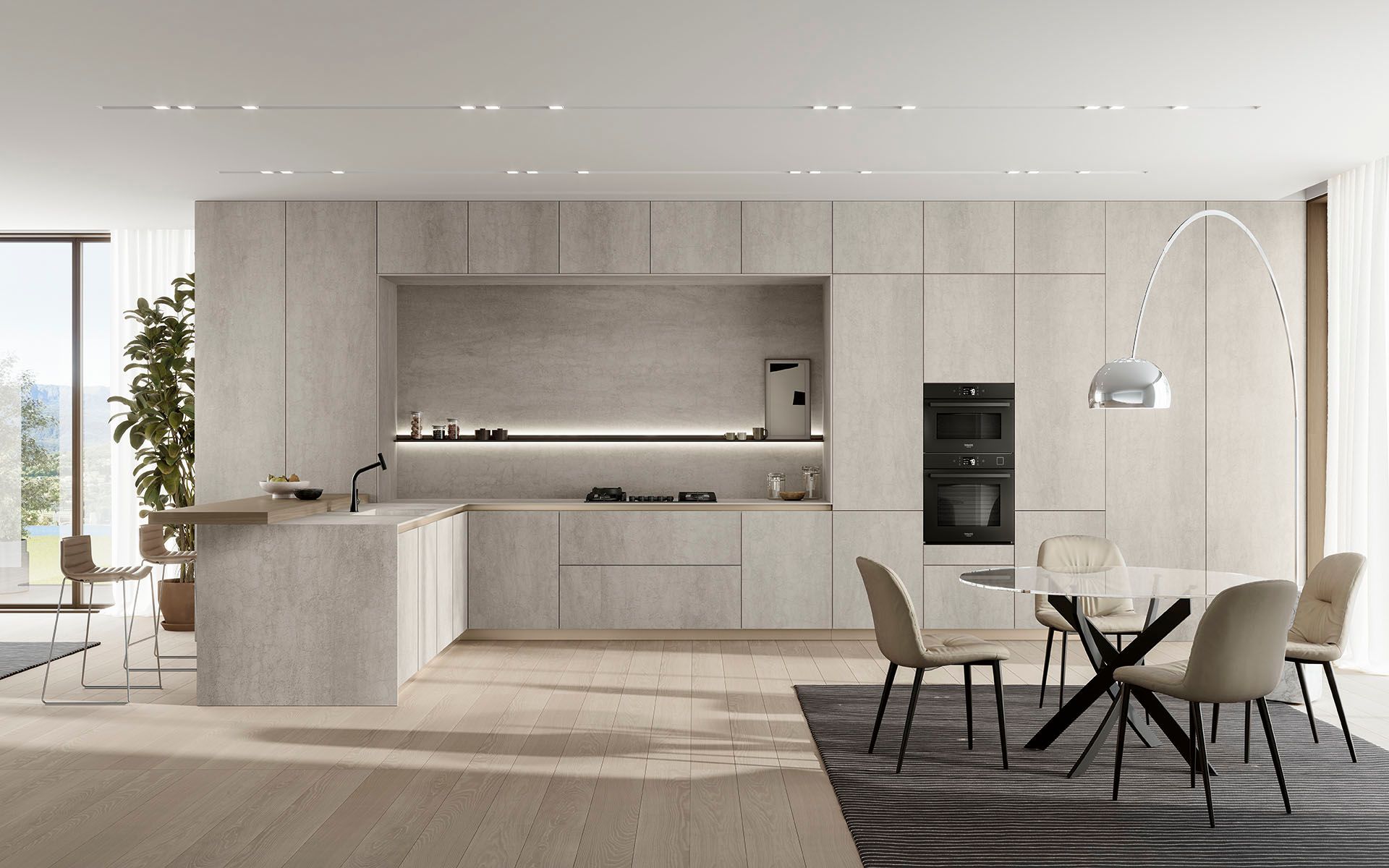 Cucina e zona pranzo moderne e minimaliste con mobili in legno chiaro, isola centrale e sedie da pranzo nere.