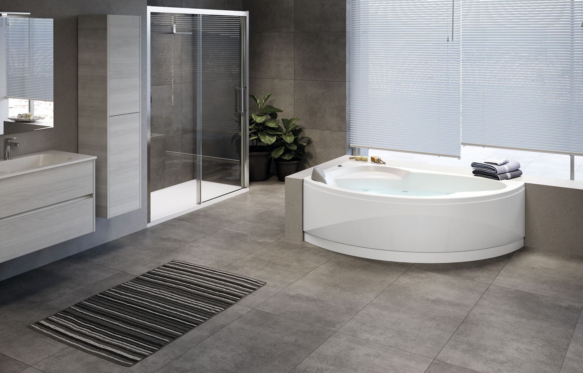 Bagno moderno con vasca angolare bianca, box doccia in vetro, lavabo e pavimento piastrellato in grigio.