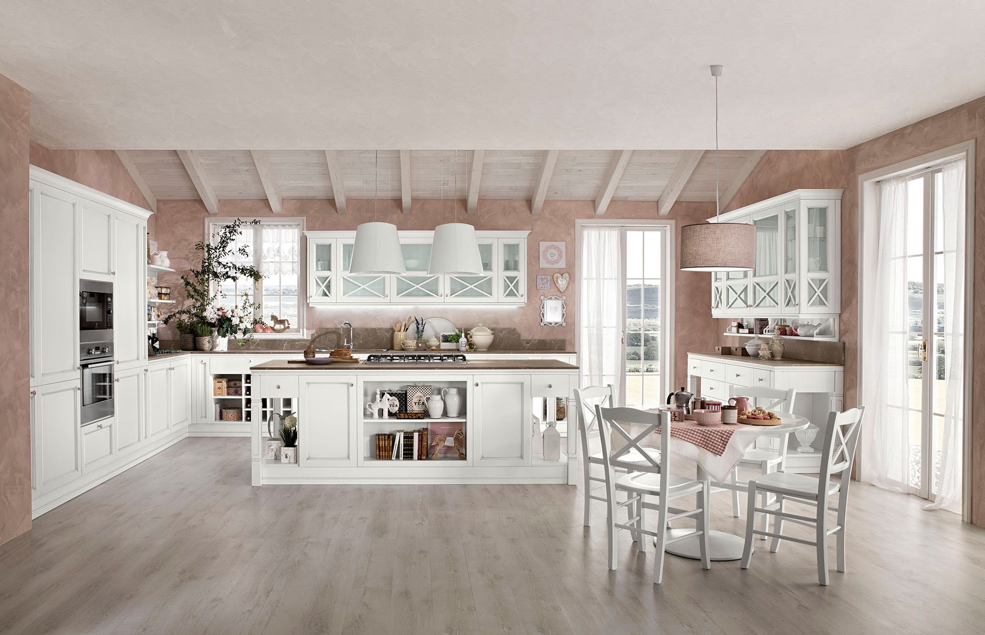Cucina e zona pranzo dai colori pastello luminosi con mobili bianchi, mensole a vista e un albero decorato vicino alla finestra.