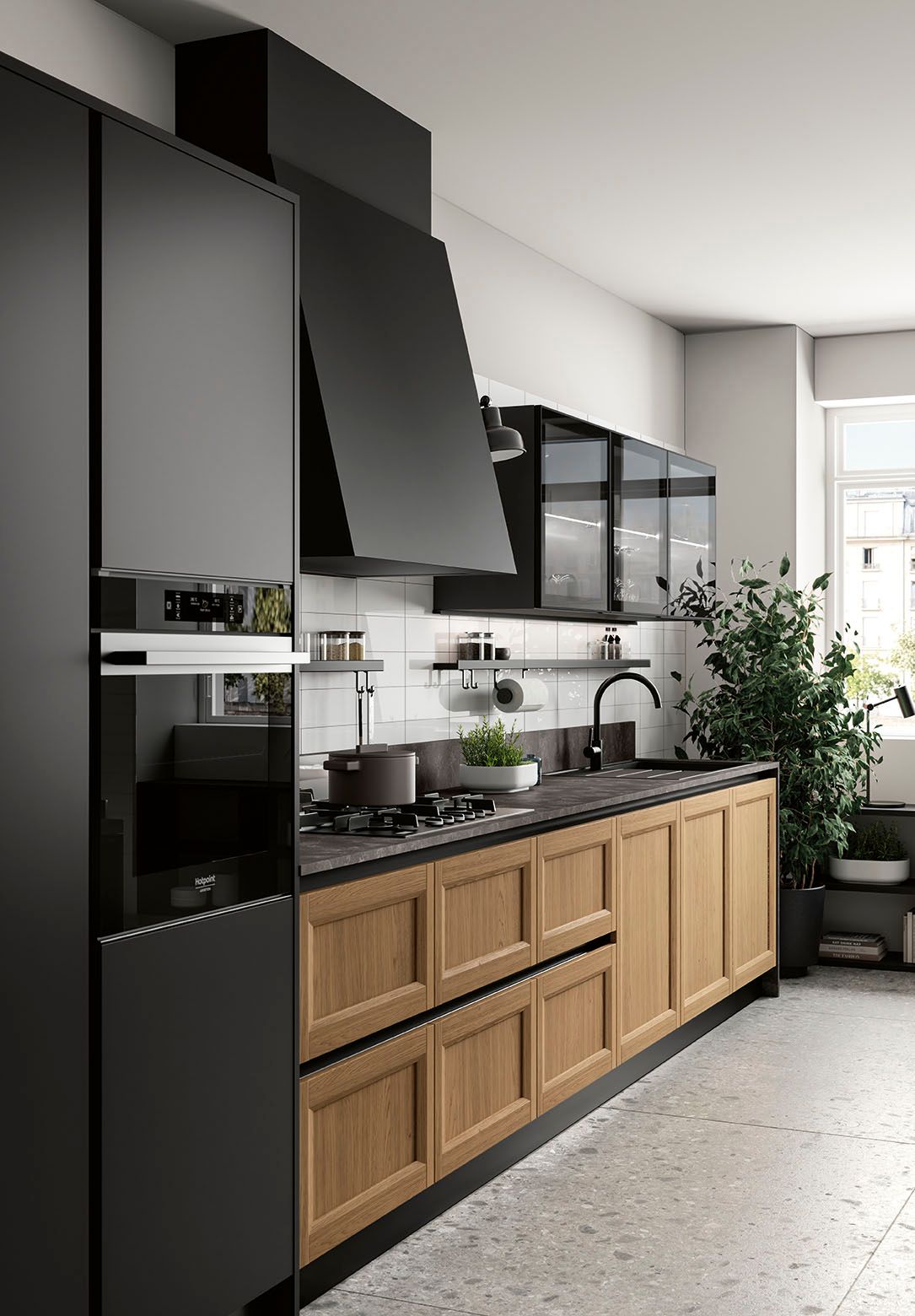 Cucina moderna con mobili neri, cassetti inferiori in legno e piante vicino a una finestra luminosa.