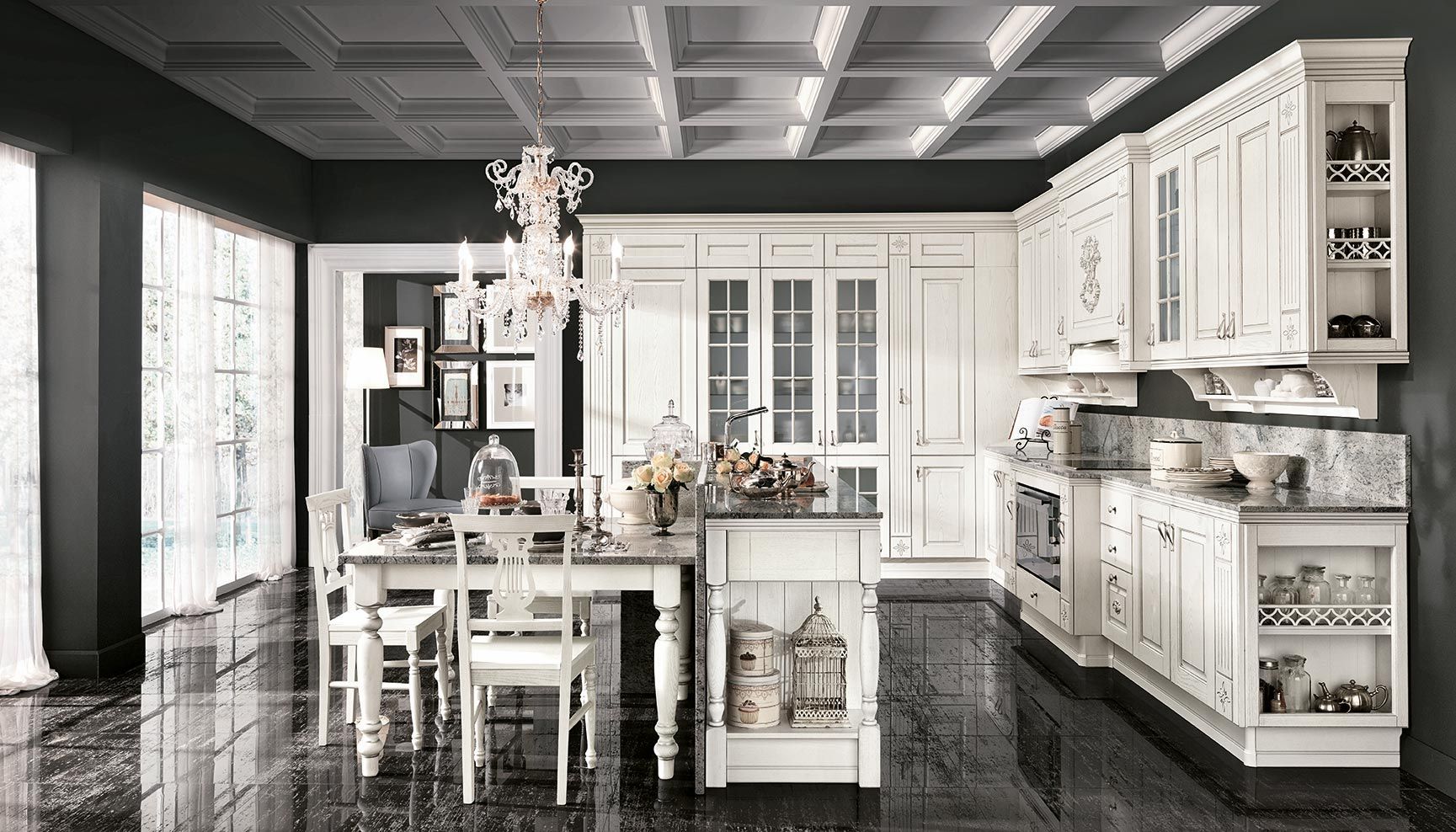 Elegante cucina bianca con isola, lampade a sospensione e pavimento nero lucido.