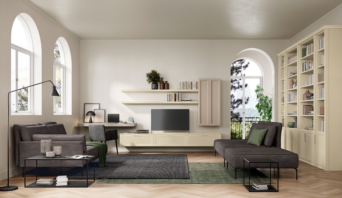 Luminoso soggiorno moderno con divani grigi, TV su mobile a parete, piante e alte finestre ad arco.