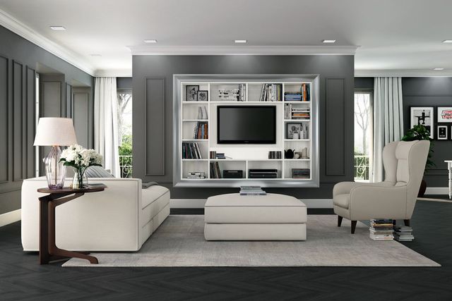 Soggiorno moderno grigio con mobili bianchi e mensole integrate per la TV sotto ampie finestre.