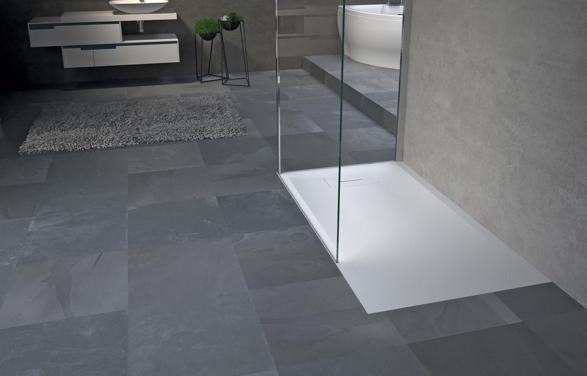 Bagno moderno con pavimento in piastrelle grigie, box doccia in vetro e mobile lavabo bianco sullo sfondo.