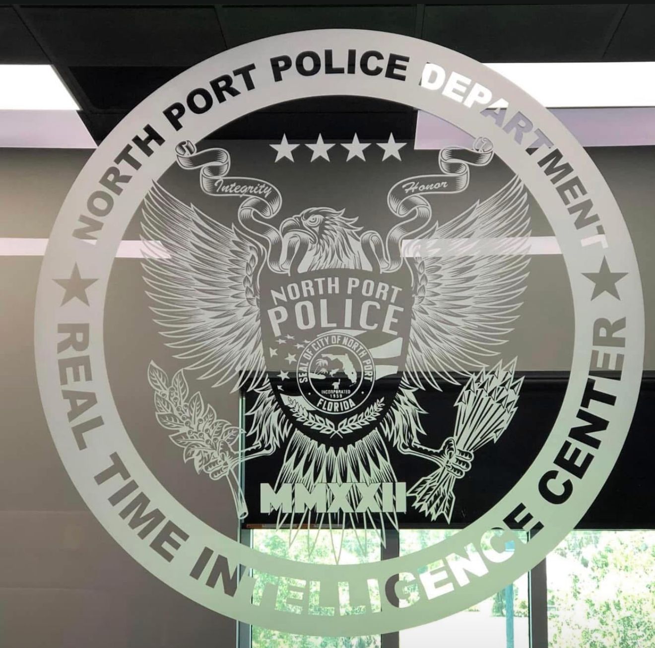 North Port Police Department logo on glass window: seal with eagle, stars, text 