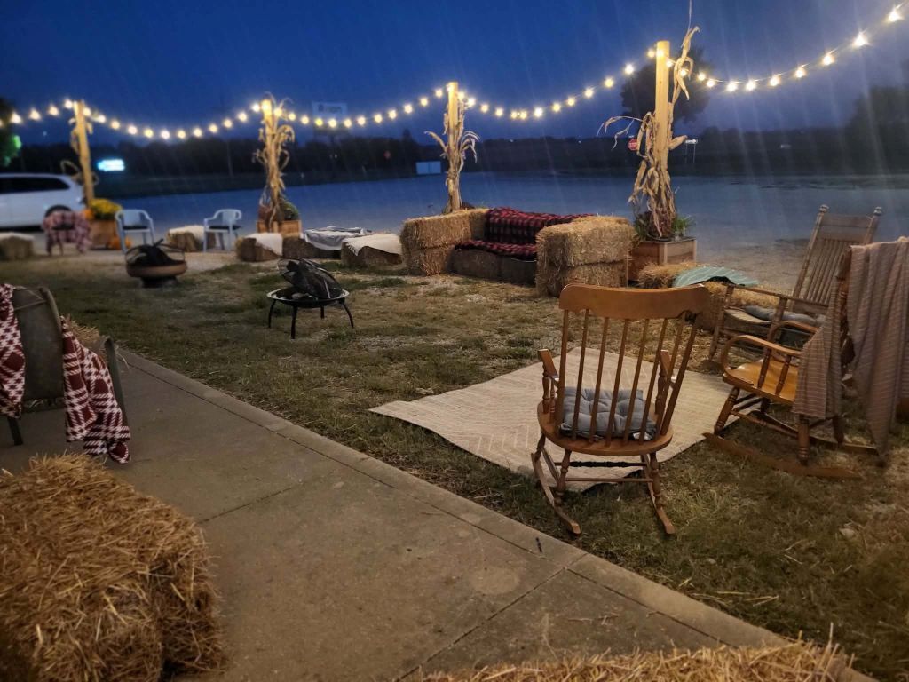 Outdoor event space in Centerview Missouri with hay bales, string lights, and rocking chairs.