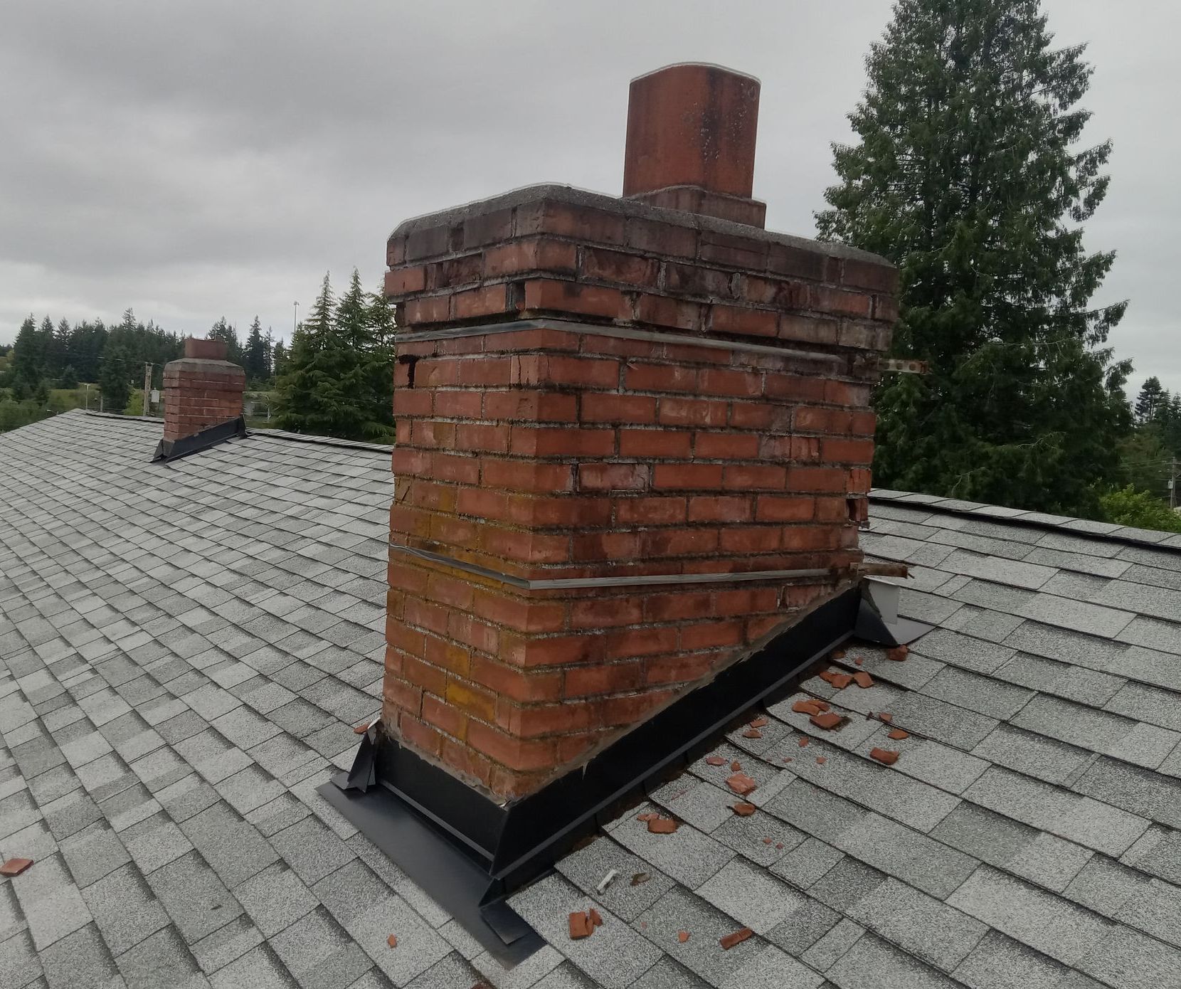 A brick chimney is sitting on top of a pile of tarp.
