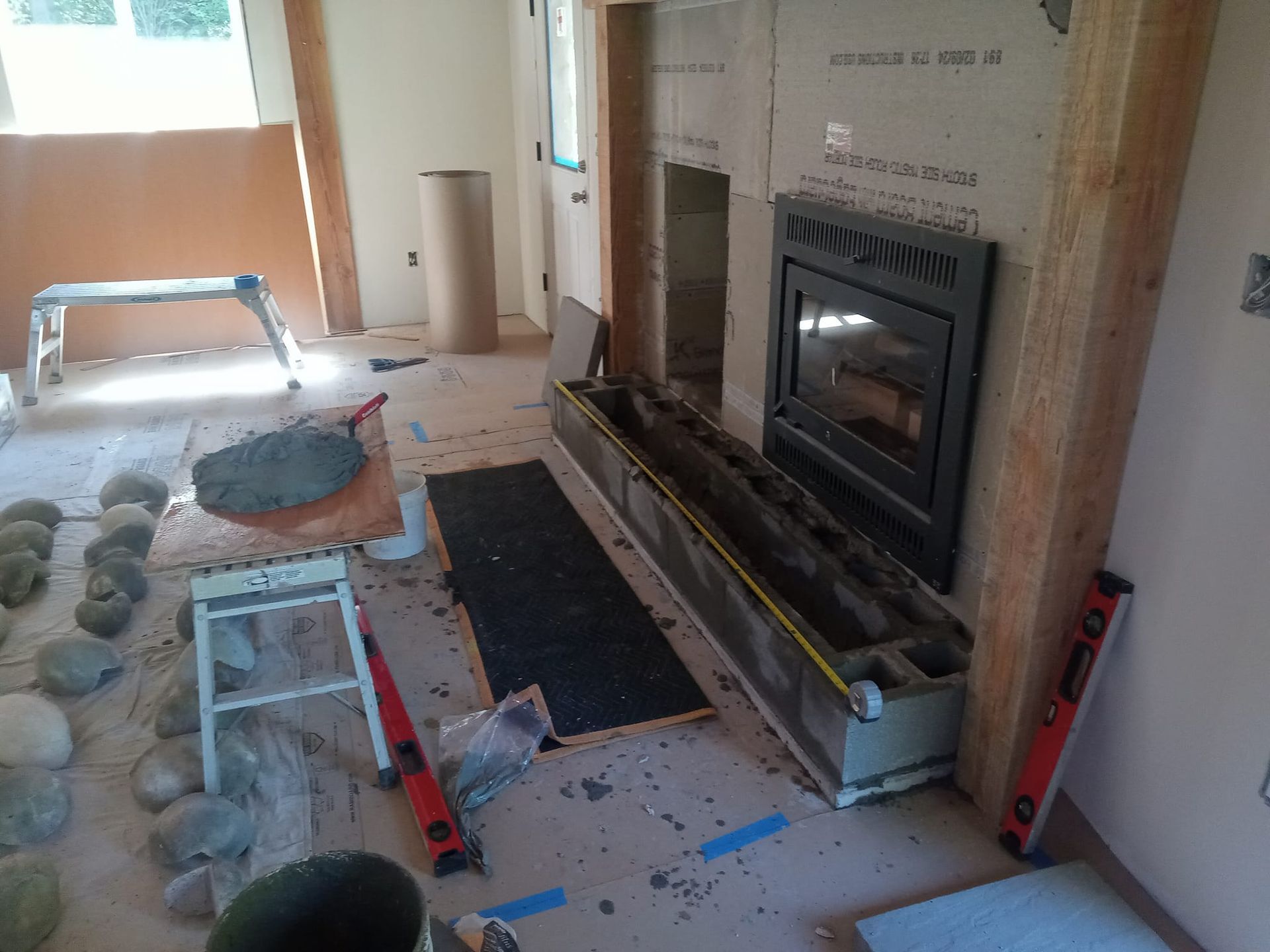 A fireplace is being built in a living room