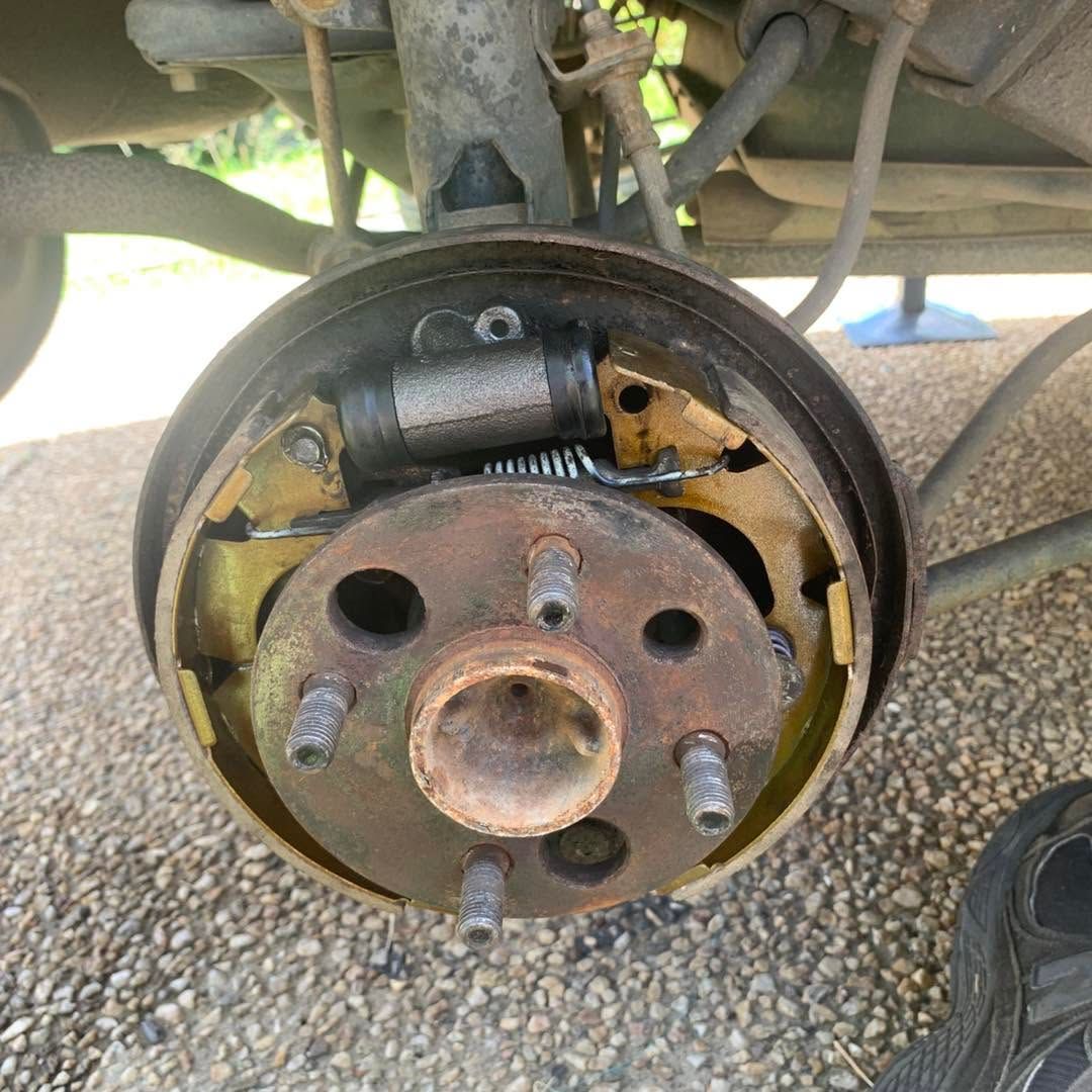 Close-up of a car brake drum assembly with exposed hub, springs, and rusted metal components — Calvin's Mobile Mechanics In Elanora, QLD