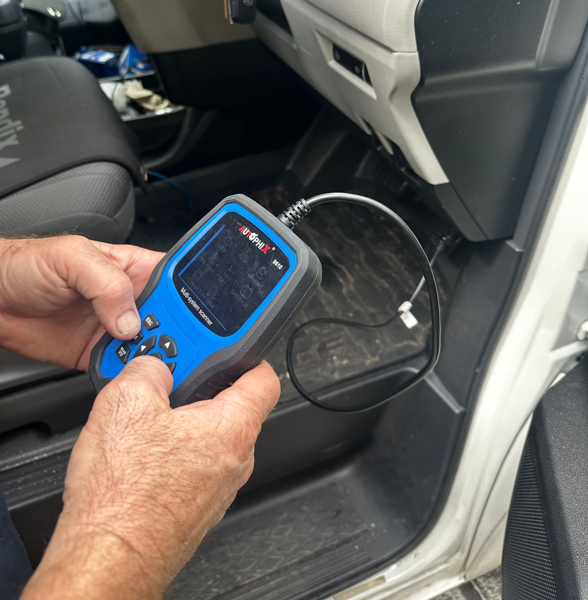 Mechanic Using a Multimeter to Test a Car Engine — Calvin's Mobile Mechanics In Elanora, QLD