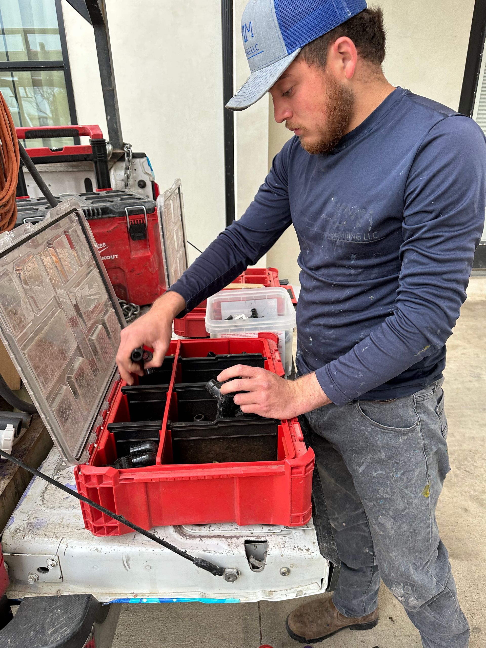 Plumber organizing tools outdoors for seasonal plumbing problems in Texas