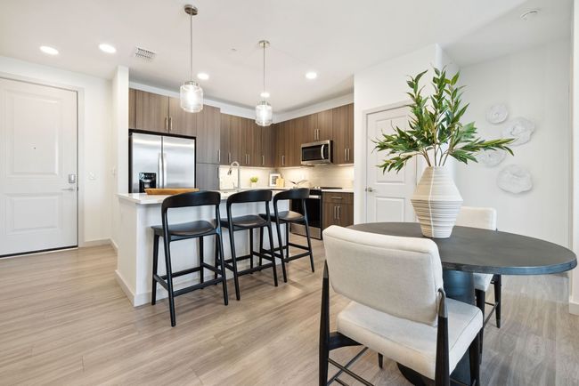 A kitchen and dining room in a house with a table and chairs.