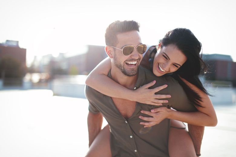 A man is carrying a woman on his back.