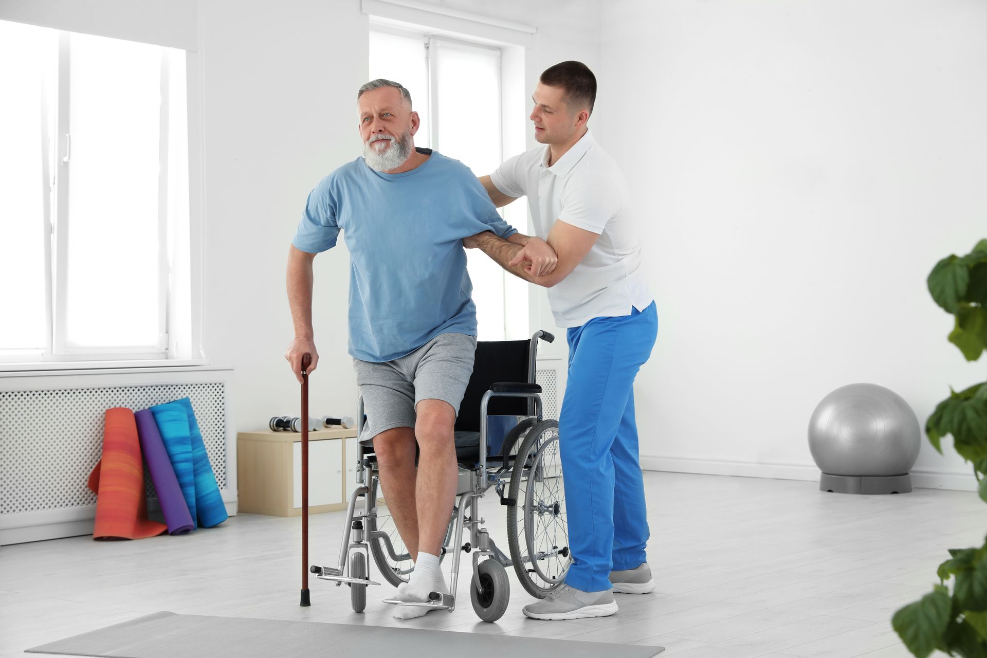 A physiotherapist is working with a senior patient in a rehabilitation center.