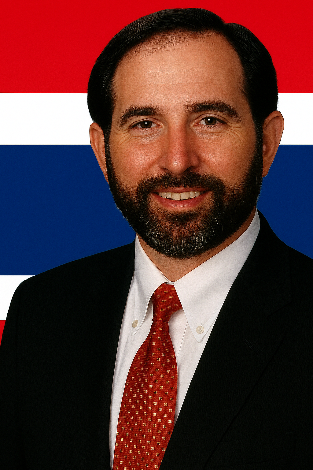 Man in a suit, red tie, smiling; background features the flag of Thailand.