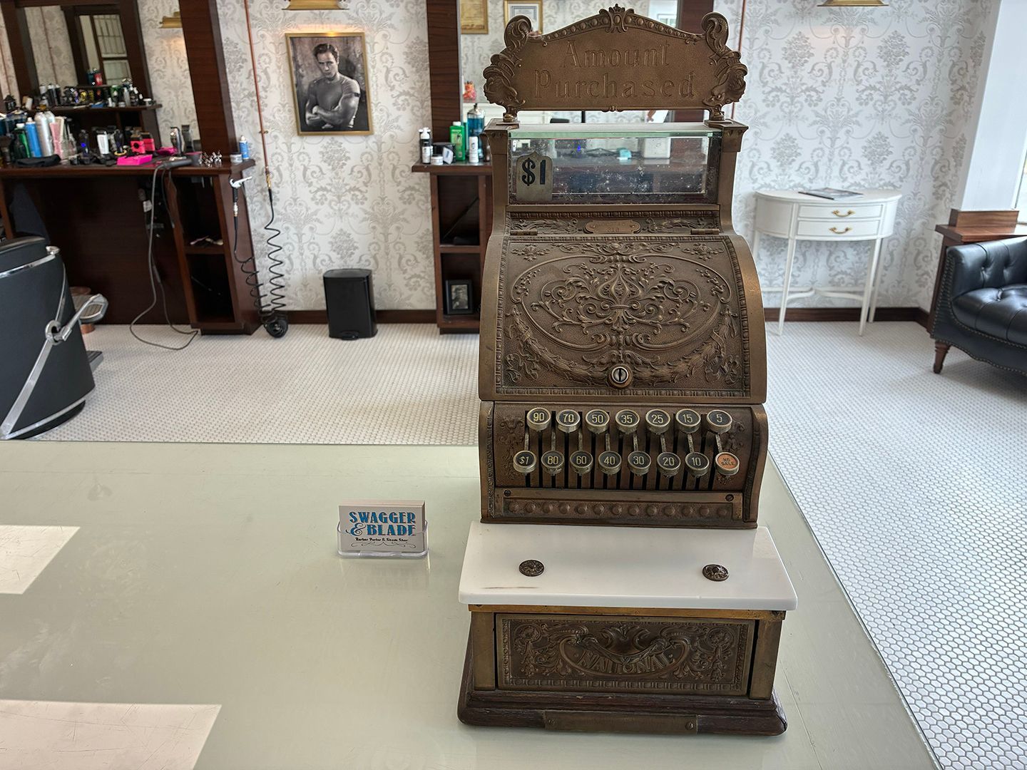 Antique cash register and vintage barber shop decor displayed inside Swagger & Blade in Monmouth County, NJ.