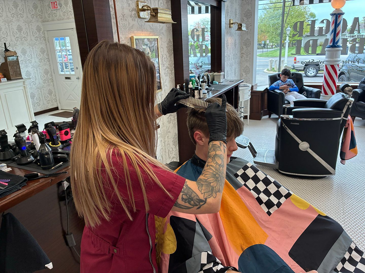 Barber providing a precision men's haircut at Swagger & Blade barbershop in Monmouth County, NJ.