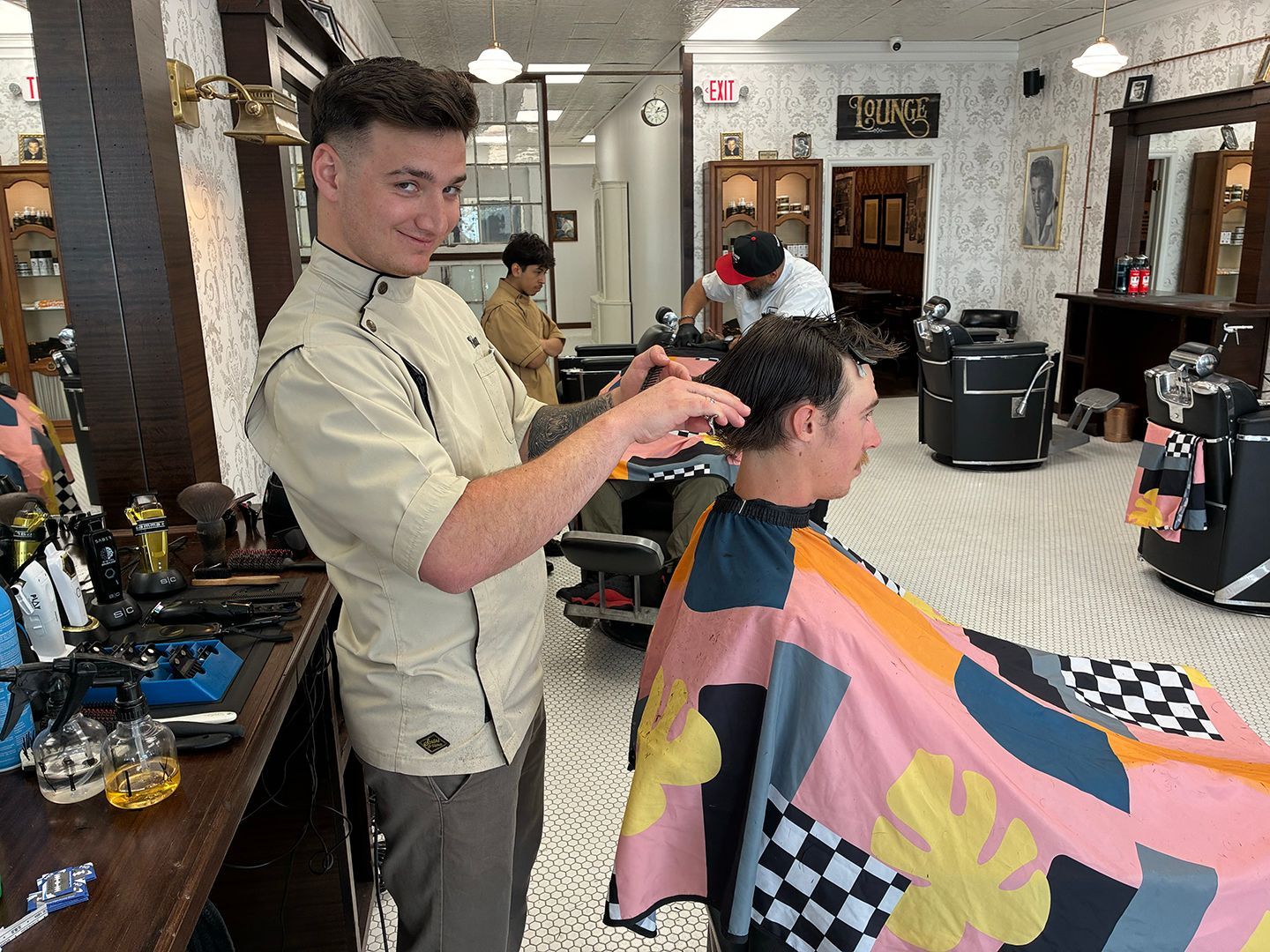 Experienced barber creating a custom men's haircut at Swagger & Blade in Monmouth County, NJ.