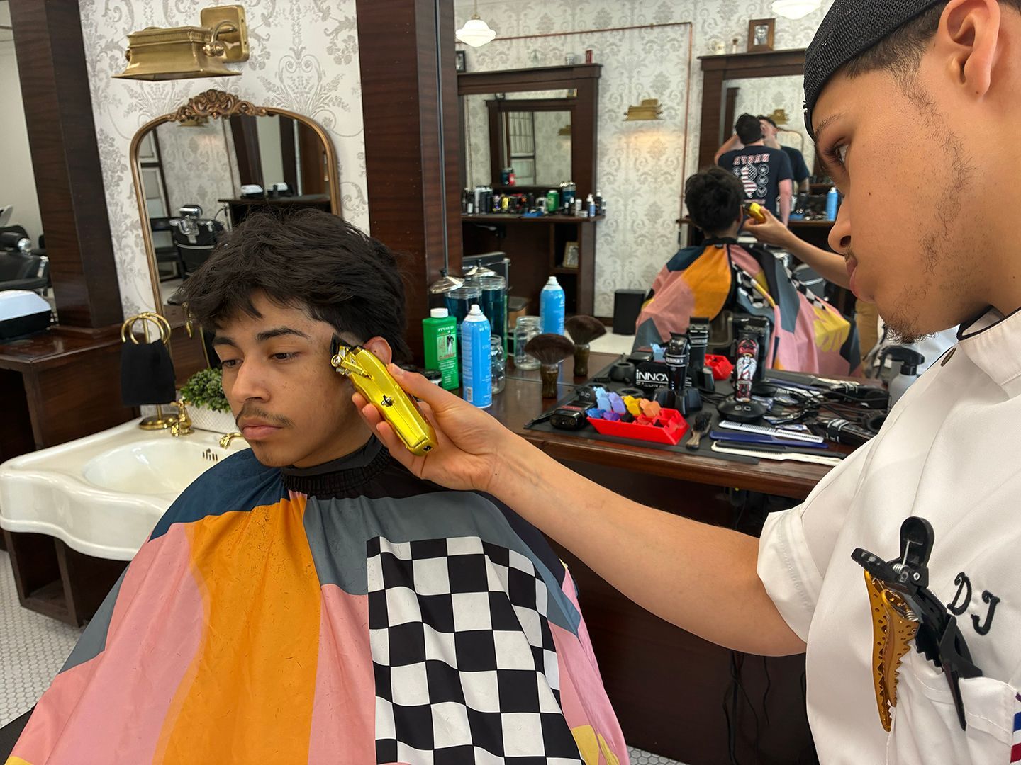 Professional barber providing a men's haircut at Swagger & Blade barbershop in Monmouth County, New Jersey.