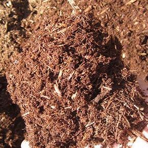 Pile of brown mulch, composed of shredded wood and organic matter.