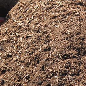 Pile of brown mulch, consisting of wood chips and organic matter.