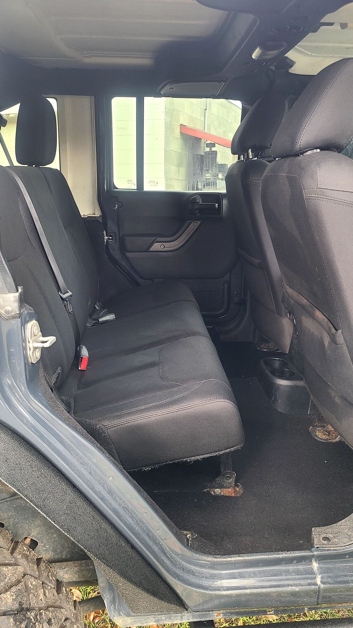 The back seat of a jeep wrangler is empty.