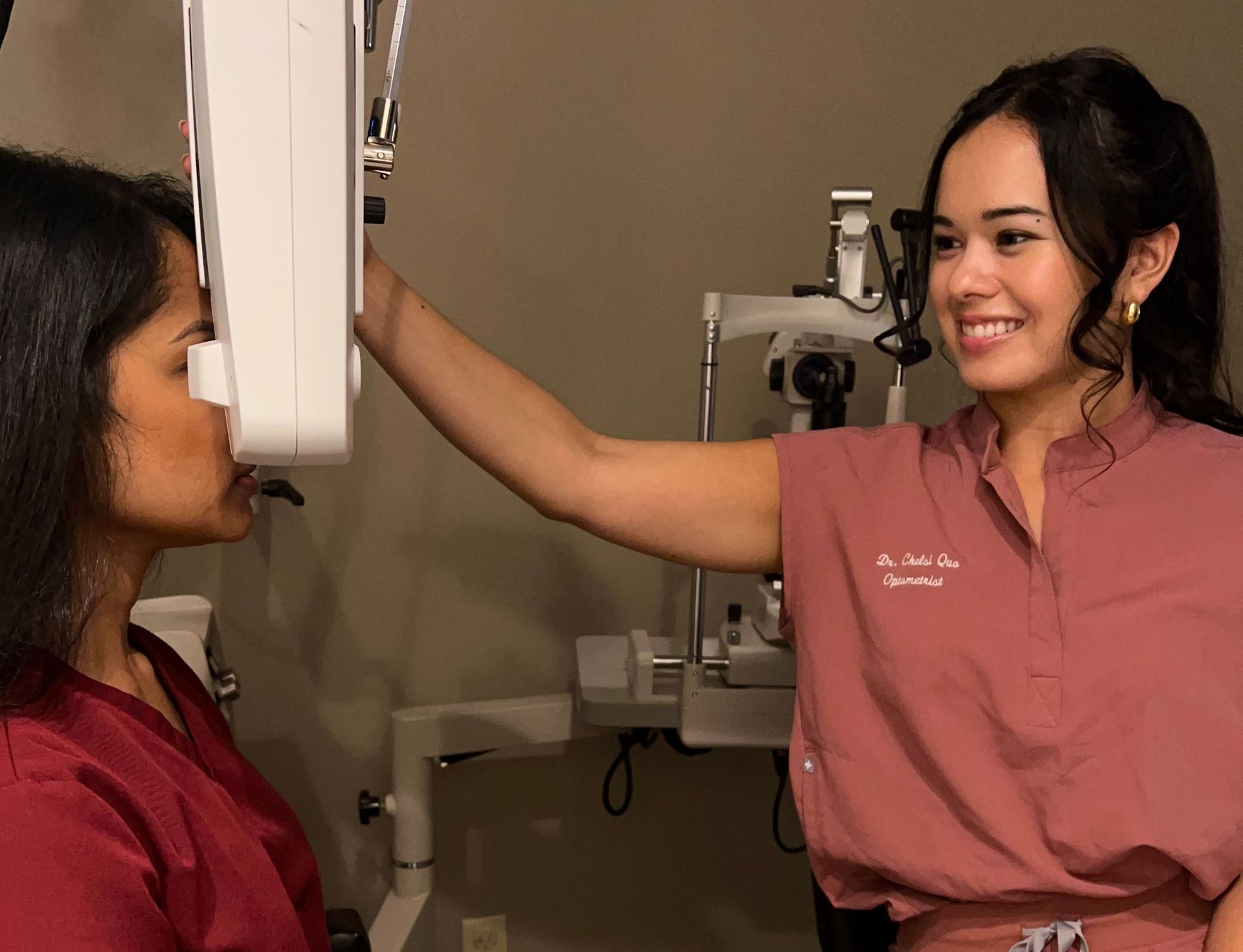 A woman is getting an x-ray of her face by an ophthalmologist.
