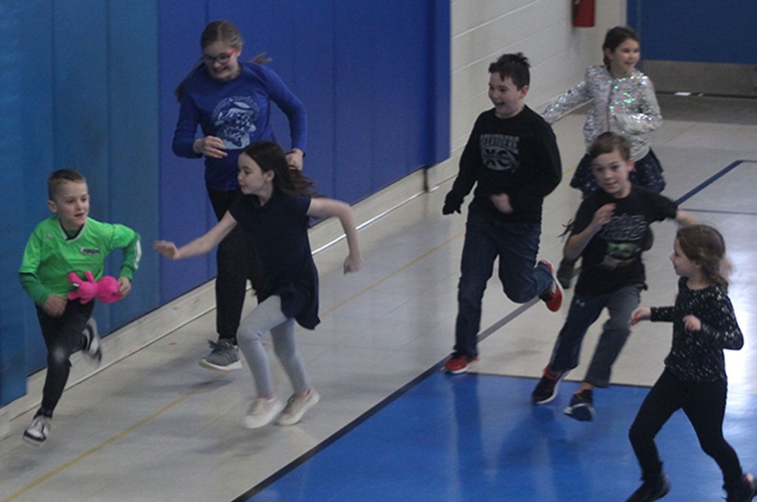 Children running in a gym; One child holds a pink stuffed animal. Immanuel Lutheran School | Belvidere, IL