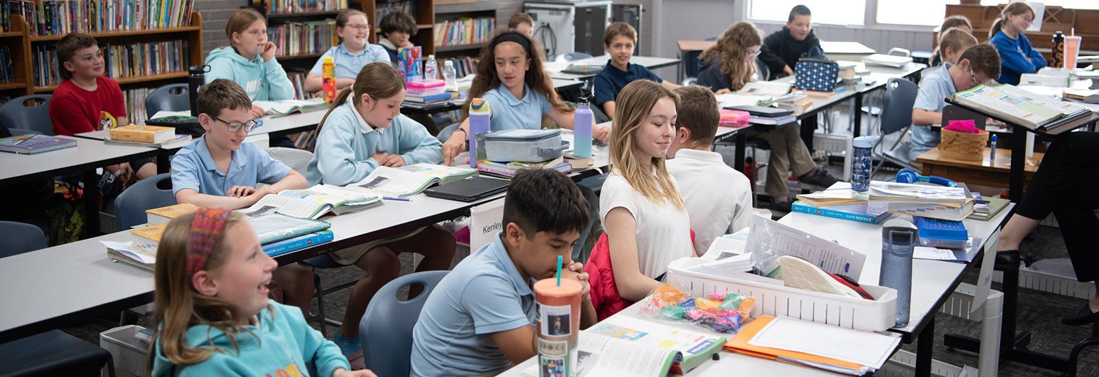Classroom of students at tables, working on assignments. Extended Care | Immanuel Lutheran School | Belvidere, IL