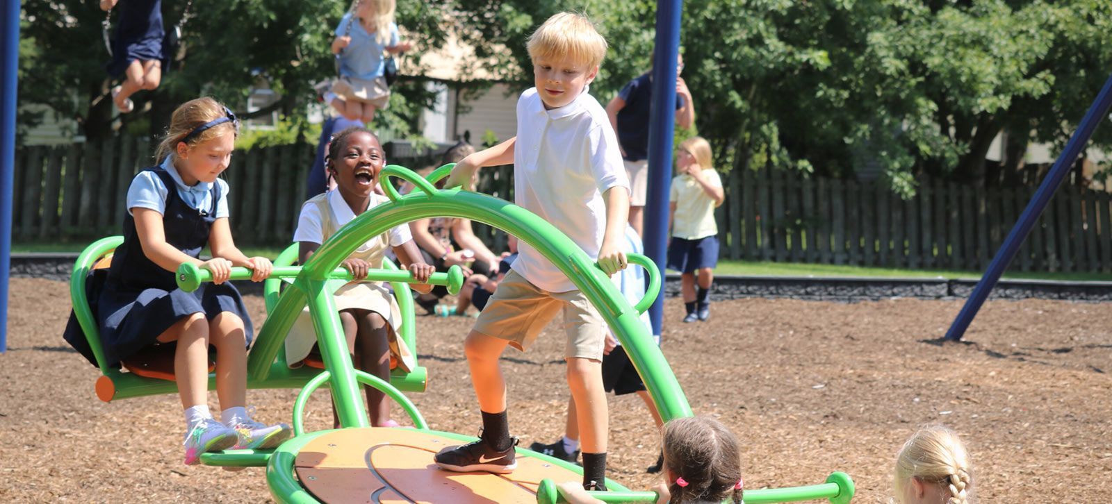 Children play on playground equipment. Extended Care | Immanuel Lutheran School | Belvidere, IL