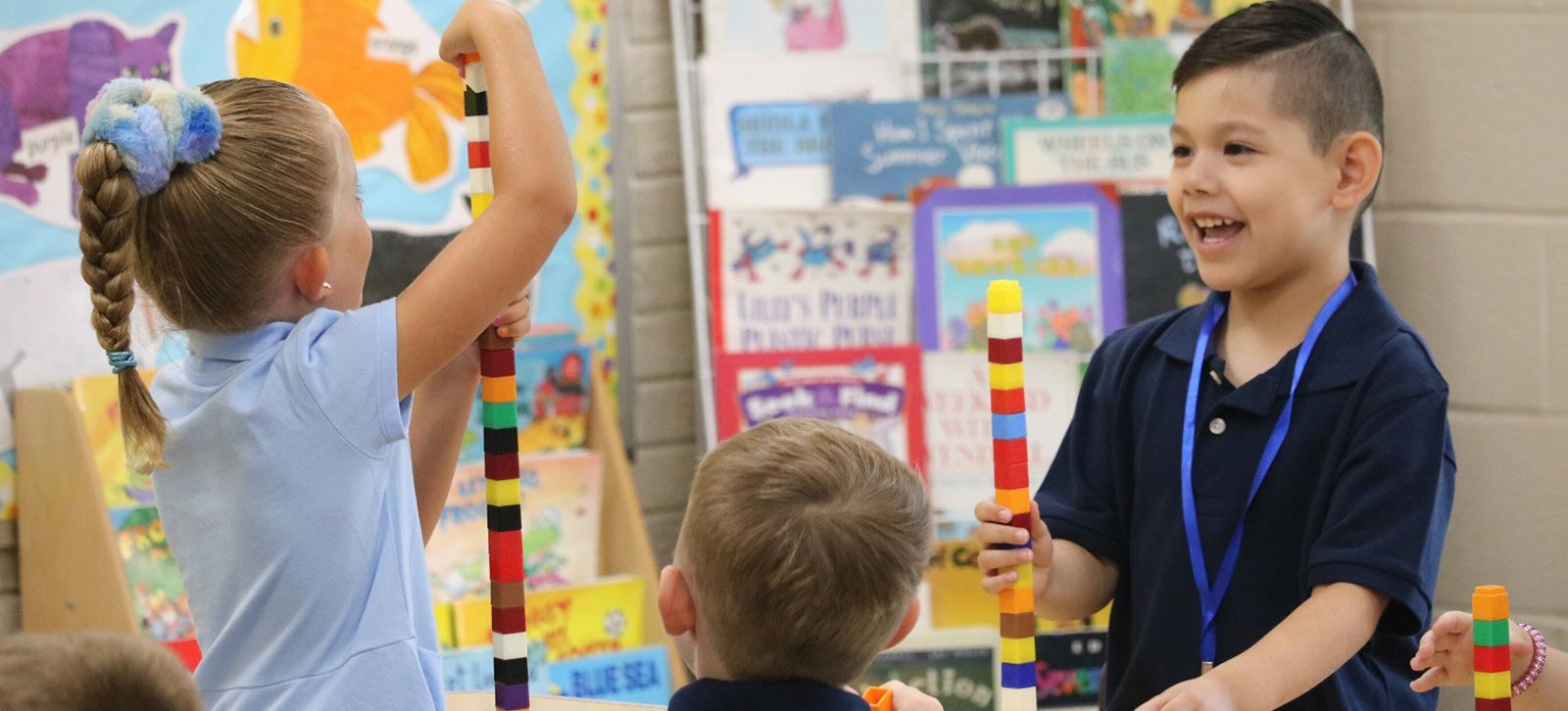 Children building colorful towers with blocks in a classroom. Extended Care | Immanuel Lutheran School | Belvidere, IL