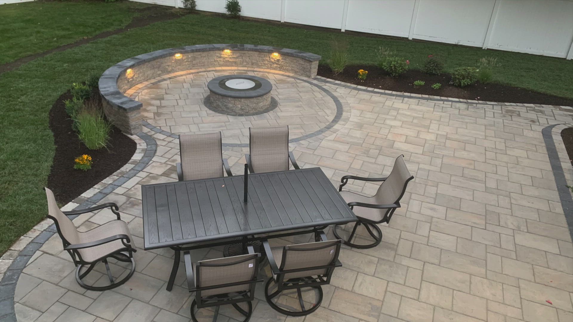 outdoor patio with fire pit and lighting