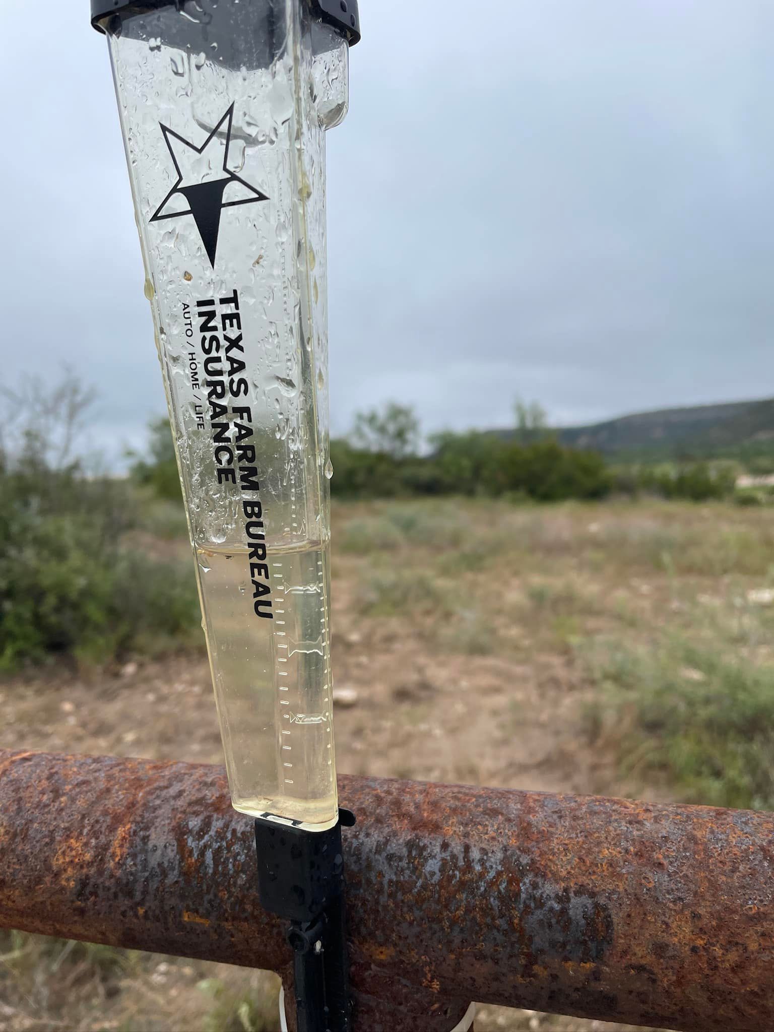 Clear plastic test tube on a rusty pipe in a grassy field, labeled “TEPASCAL HORN”